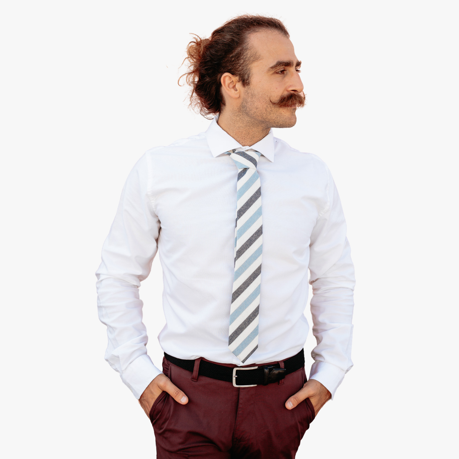 A man wearing a striped tie with light baby blue stripe, navy lines, cream bars and diagonal designs, and off-white designs.