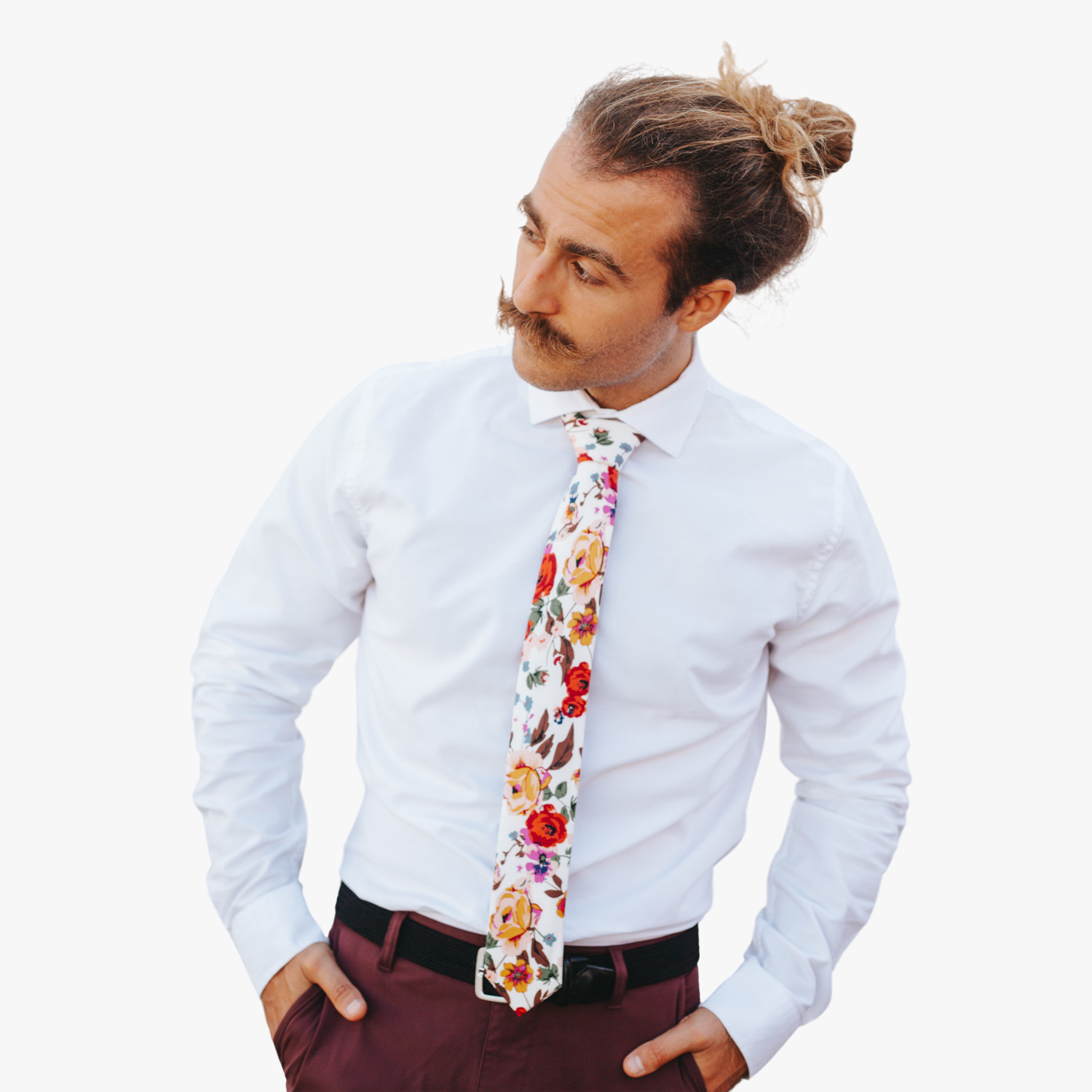 A man wearing a floral tie with  large yellow flowers, orange petals, lavender purple blossoms and green leaves.