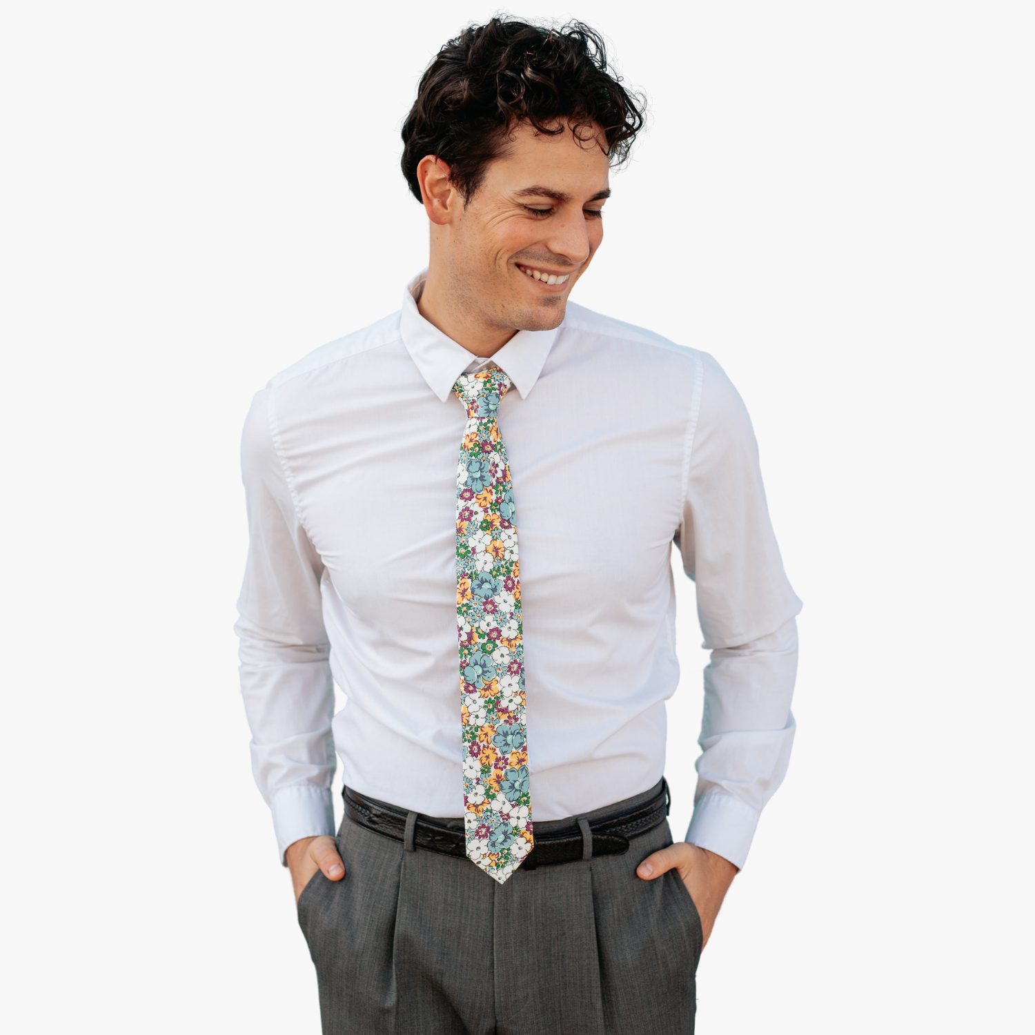 A man wearing a floral tie with pale blue flowers, yellow and burnt orange petals, white blossoms and small green flowers.