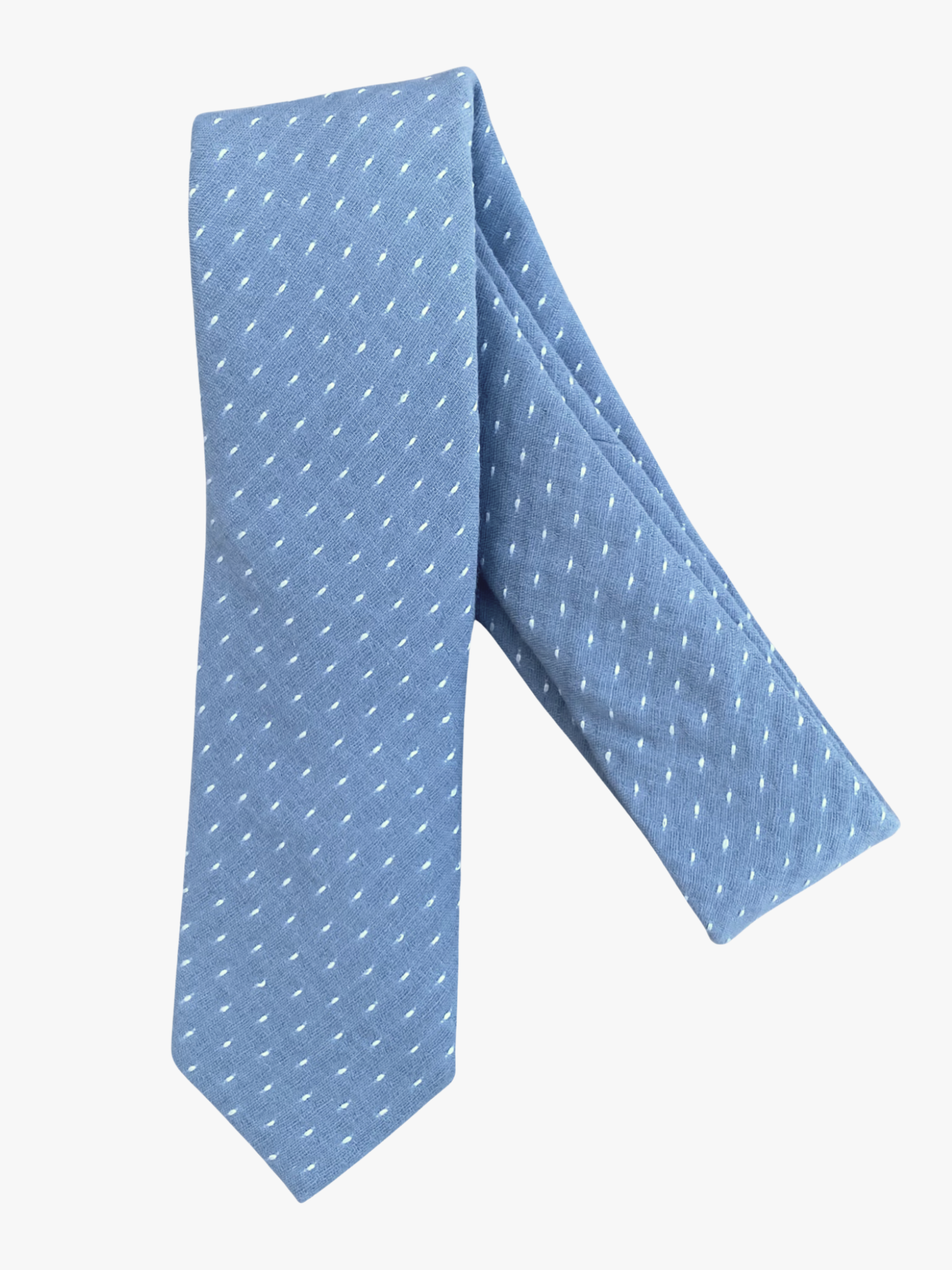 A folded polka dot adult men's necktie with a slate blue gray fabric and a simple repeating pattern of white dots or spots.