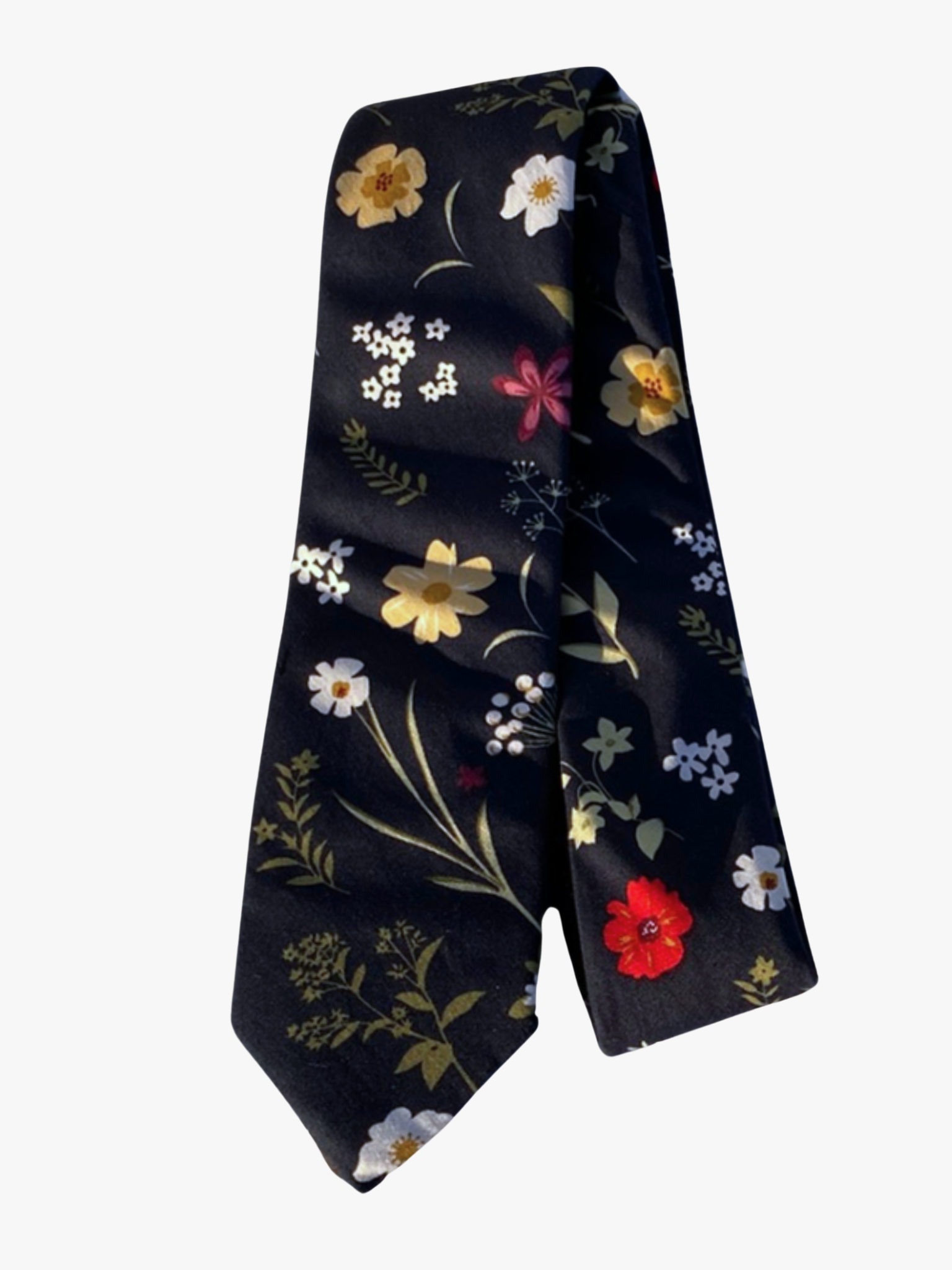 A folded floral adult men's necktie with navy blue fabric, simple dark green leaves, white, yellow, and red flowers.