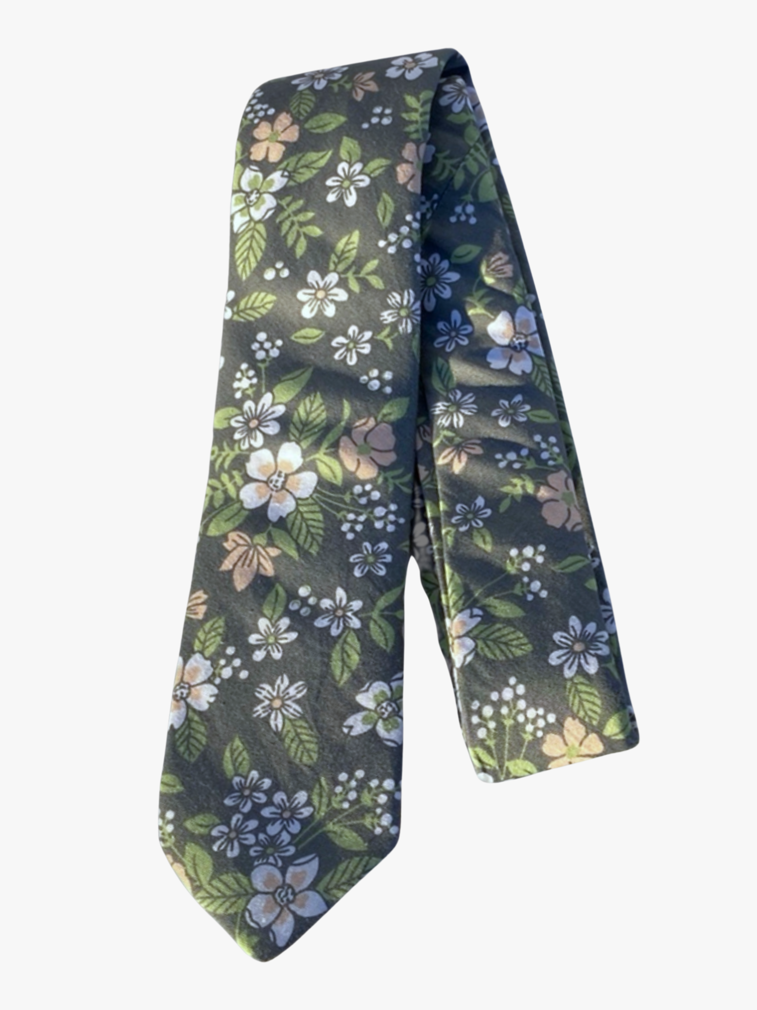 A folded floral adult men's necktie with gray fabric, bold cartoon flowers of white, pink petals, and pastel green leaves.