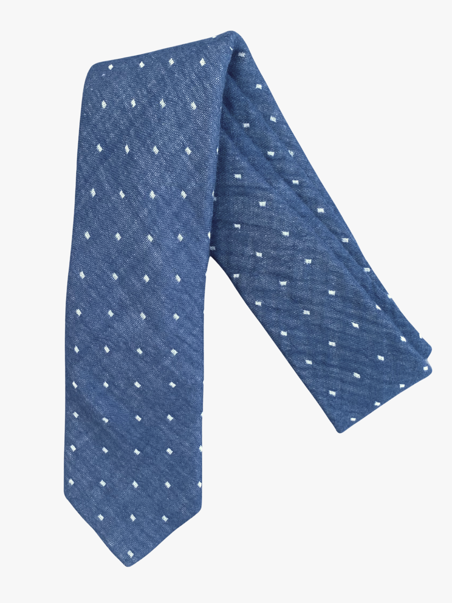 A folded polka dot adult men's necktie with navy blue fabric and a simple geometric white dot pattern.