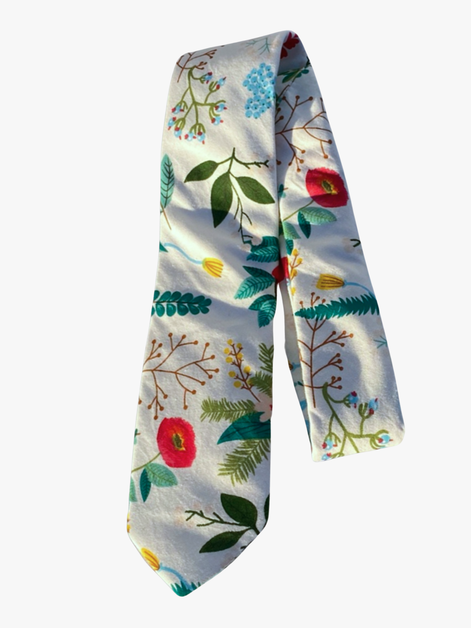 A folded floral adult men's necktie with white fabric, red flowers, brown sticks, and pale shades of green plants and leaves.