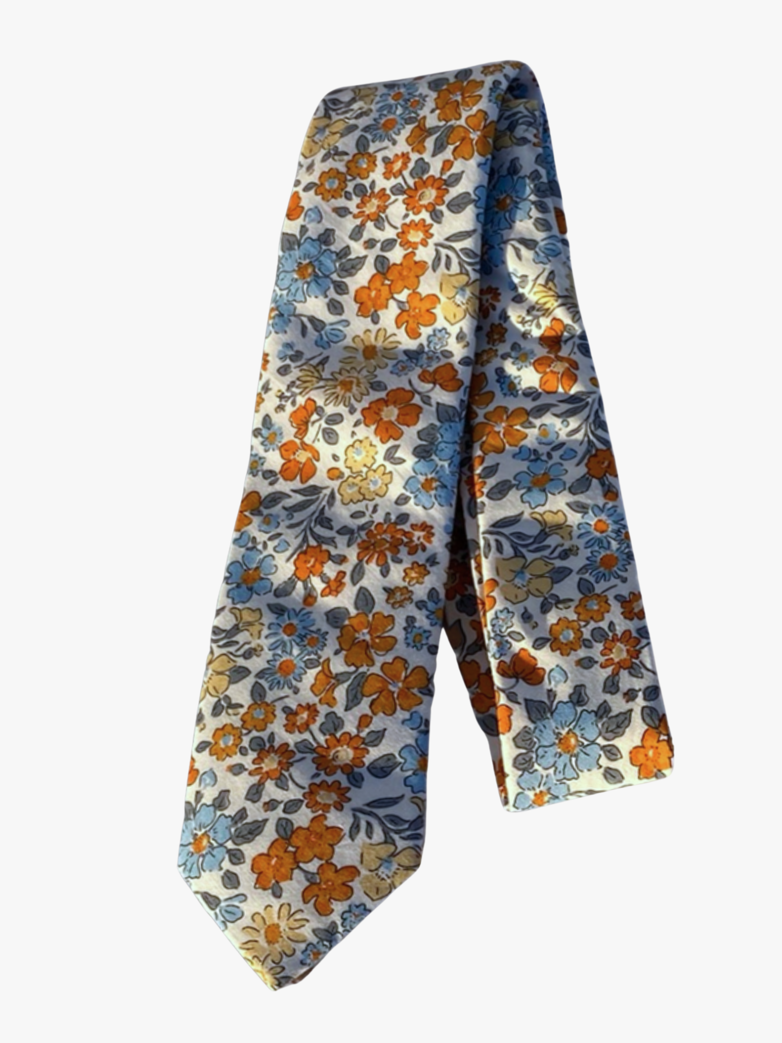 A folded floral adult men's necktie with white fabric, and dark orange, pale blue, and yellow flowers with light blue leaves.