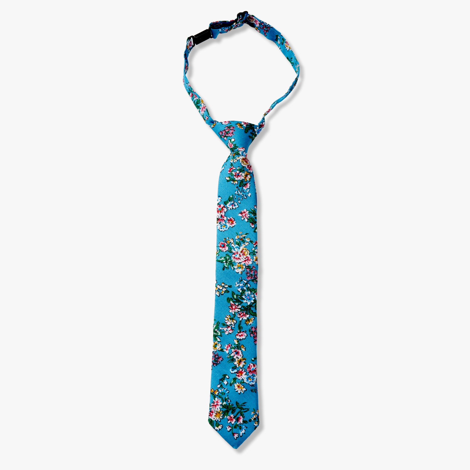 Kids floral pretied tie with watercolor turqouise flowers, pink and yellow blossoms, and green leaves on blue cotton fabric.