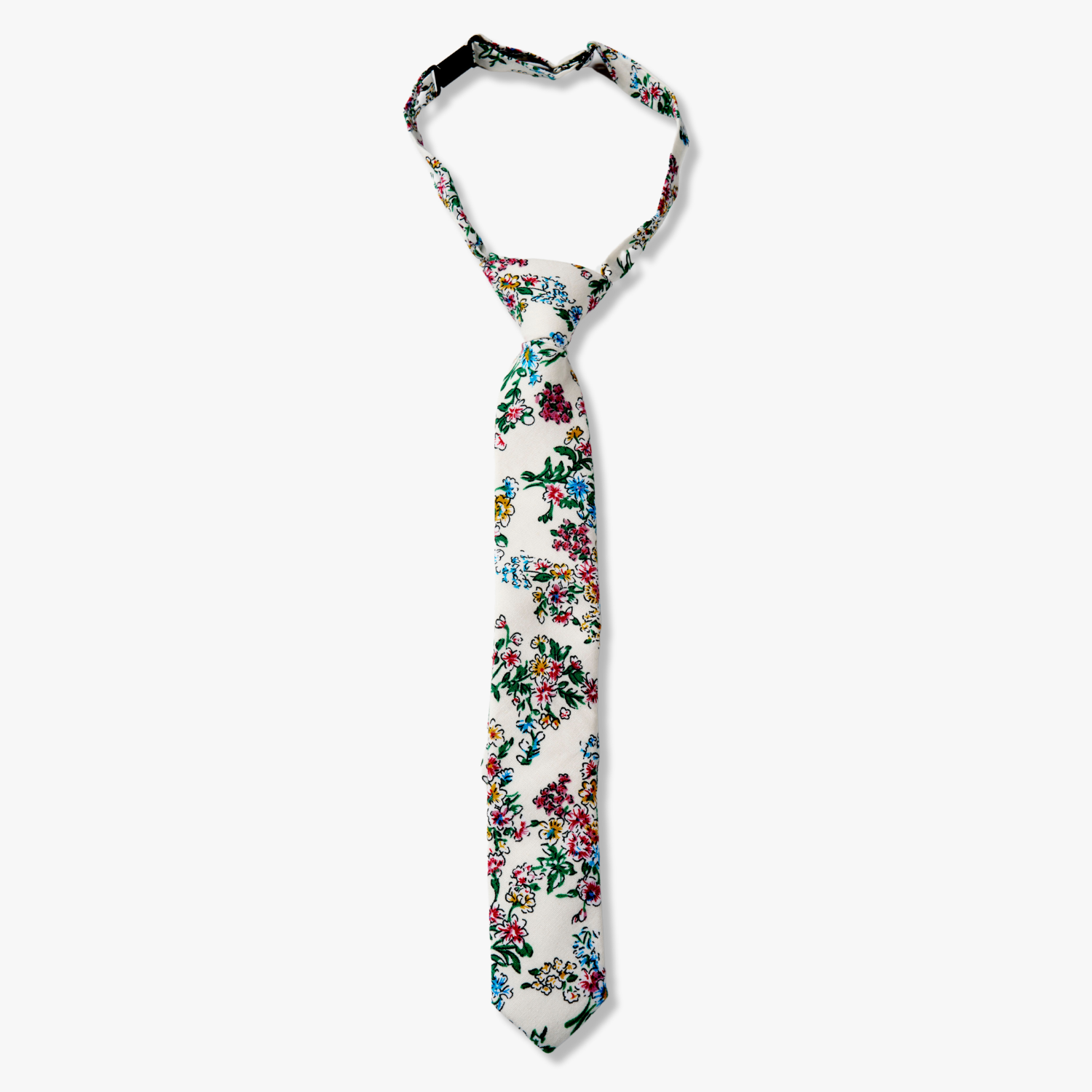 Kids floral pretied tie with watercolor turquoise flowers, pink and yellow blossoms, and green leaves on white cotton fabric.
