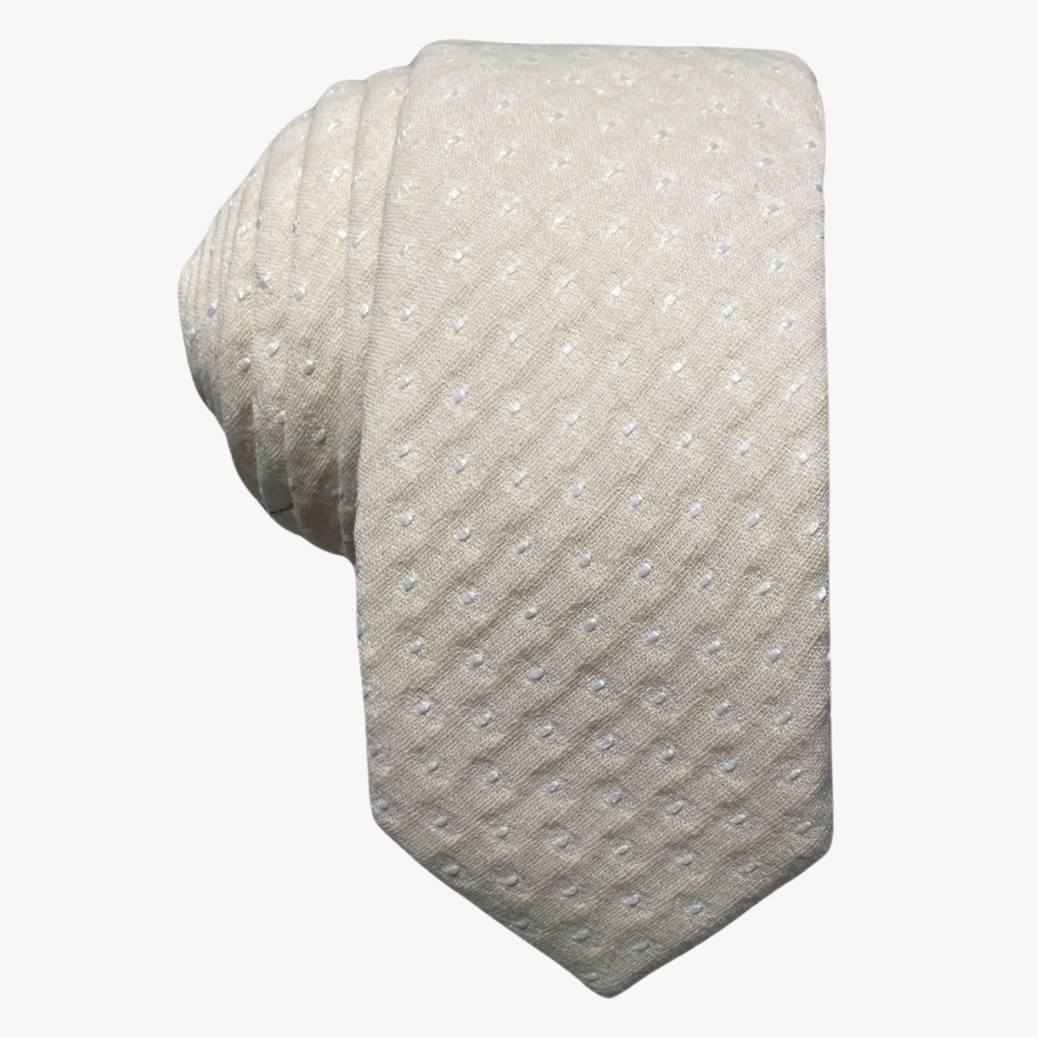 Adult mens cotton polka dot tie with a light beige tan fabric and repeating pattern of white dots or spots, and a soft feel.