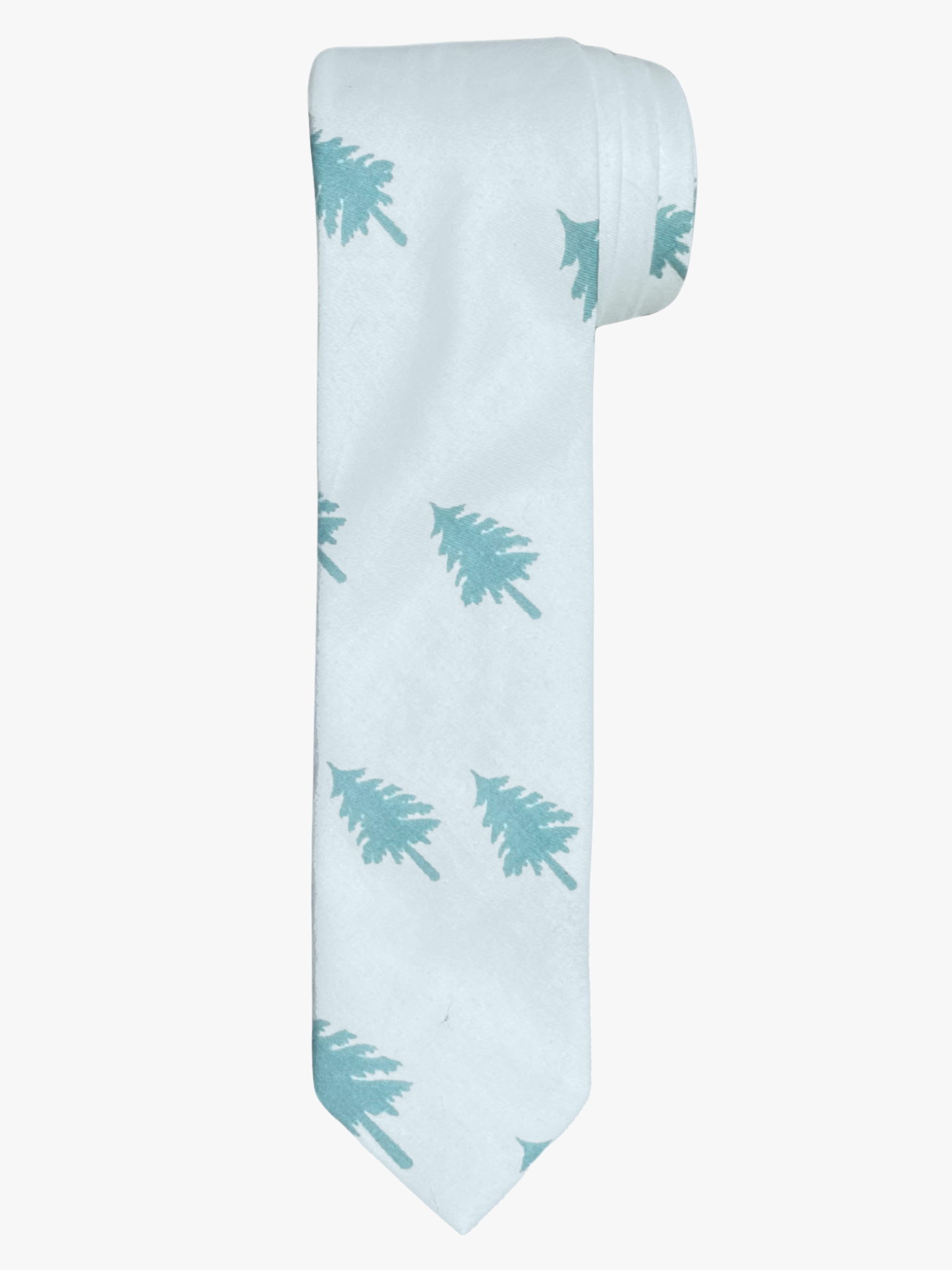 A rolled up unisex pale jade green and snowy white Christmas tree cotton necktie for teens, adults, men, and women.
