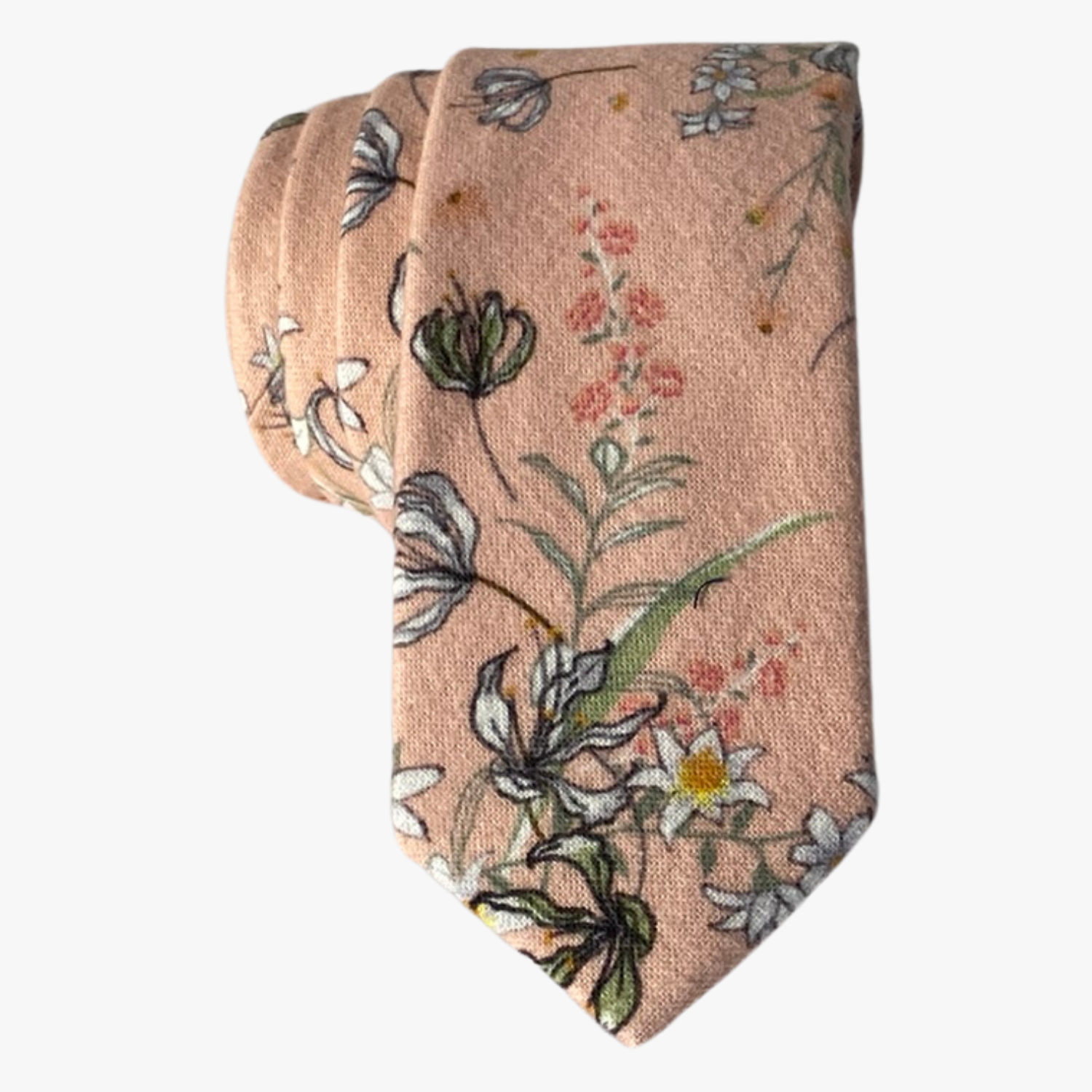 An adult peach colored cotton necktie with white and yellow flowers outlined in black, small pink flowers, and green leaves.