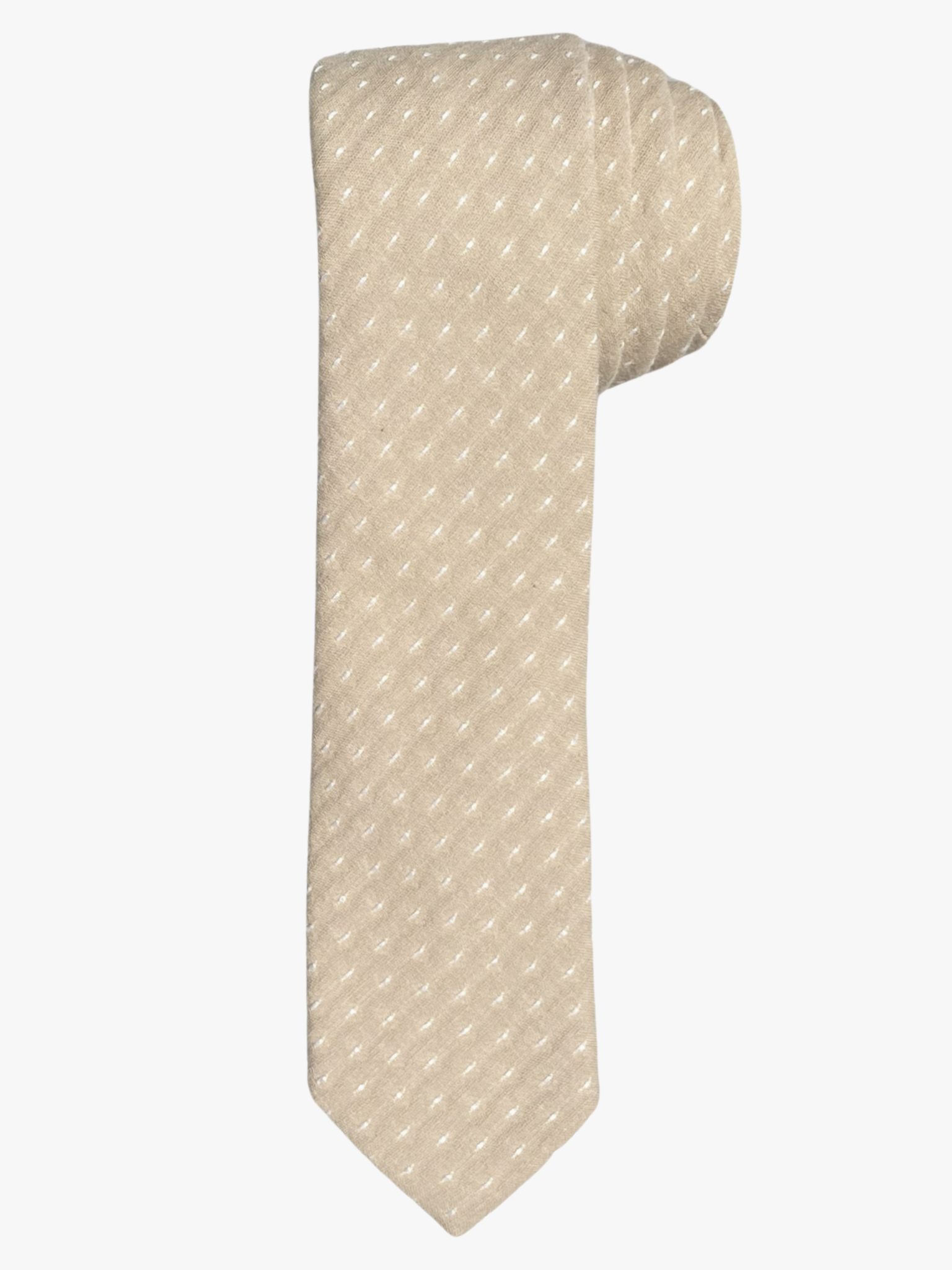 A rolled up unisex sandy tan and white polka dot cotton necktie for teens, missionaries, men, and women.