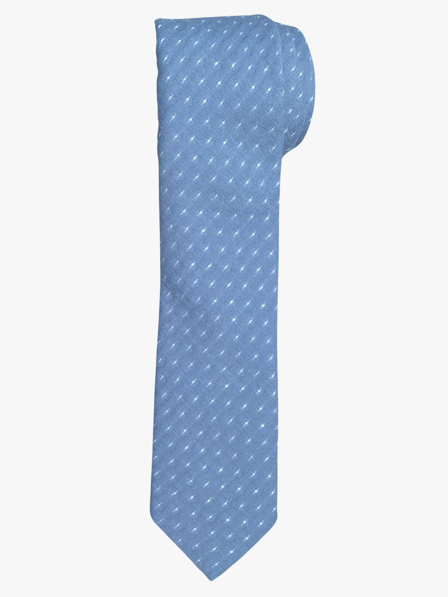 A rolled up unisex slate blue gray and white polka dot cotton necktie for teens, missionaries, men, and women.