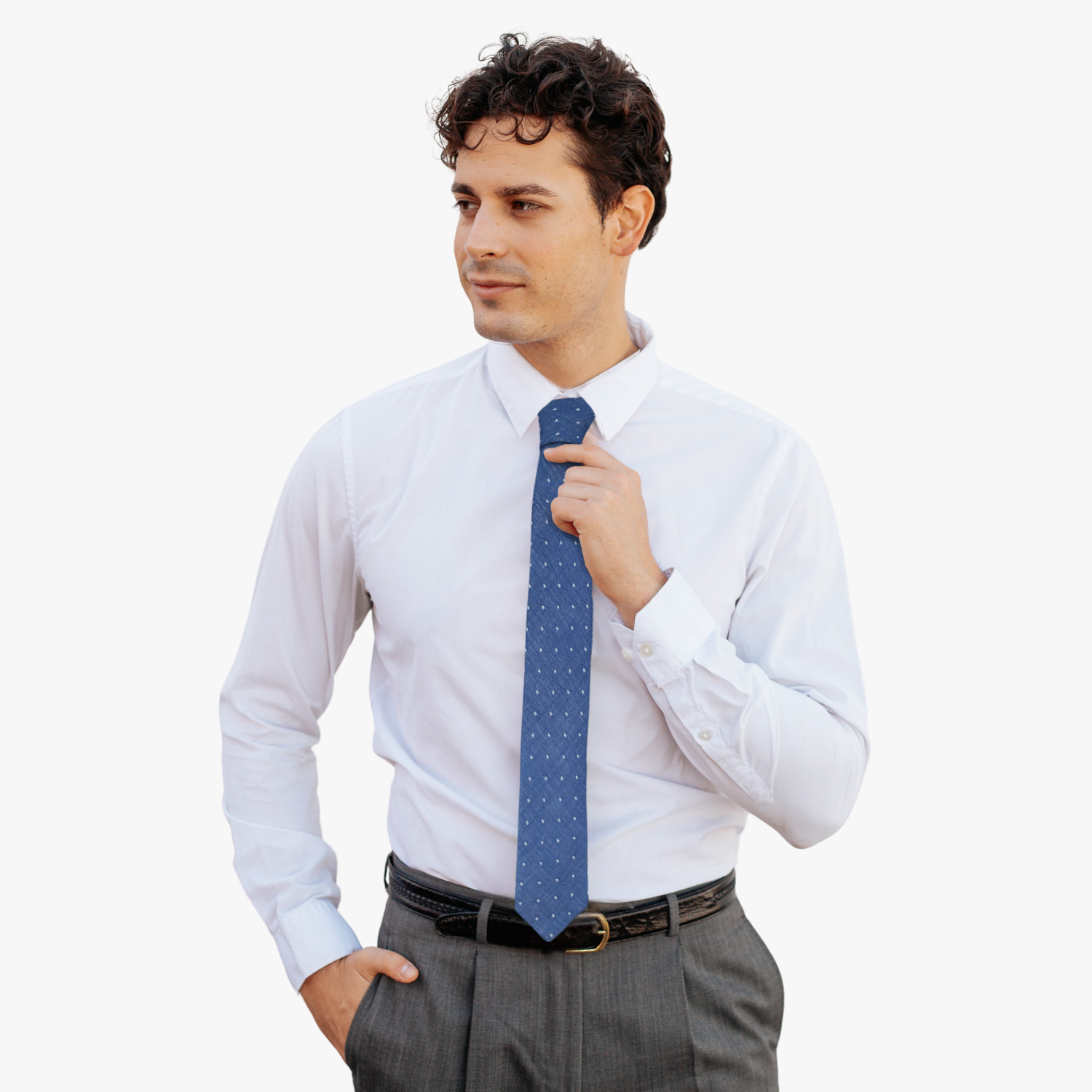 A man wearing a polka dot tie with navy blue fabric and a simple geometric white dot pattern.