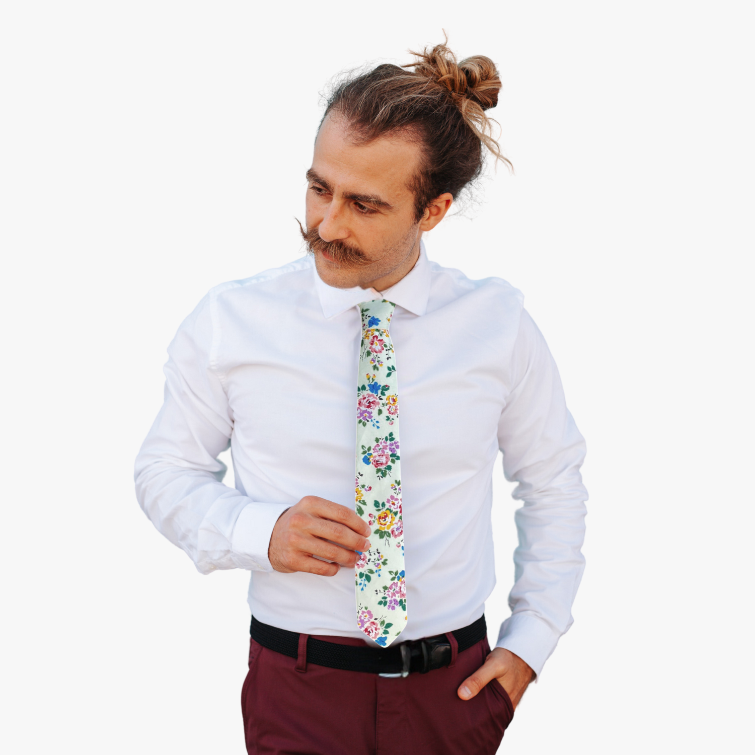 A man wearing a floral tie with and off-white green hue and dark green leaves with blue and yellow flowers and pink roses.