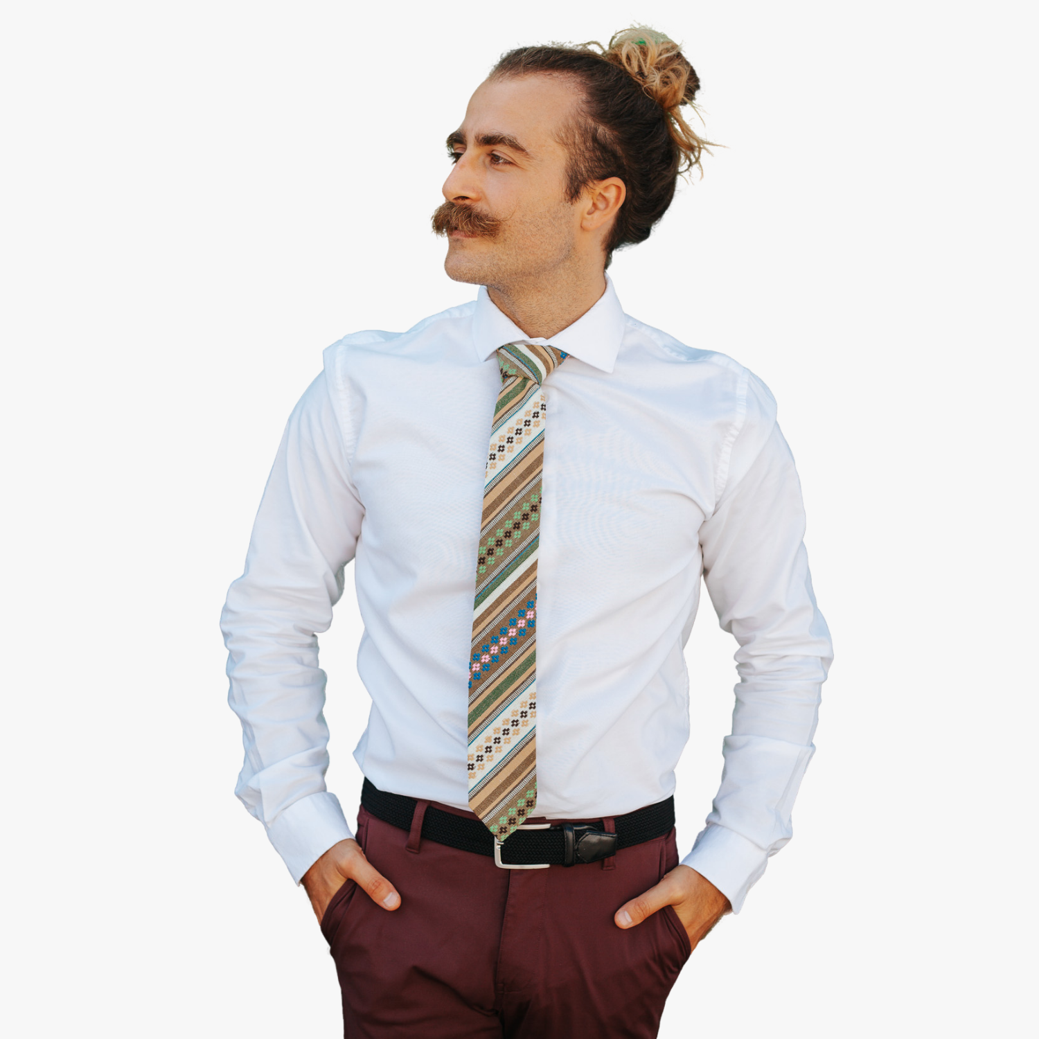 A man wearing church clothes and a striped tie with green stripe, tan lines, brown bars and cross designs.