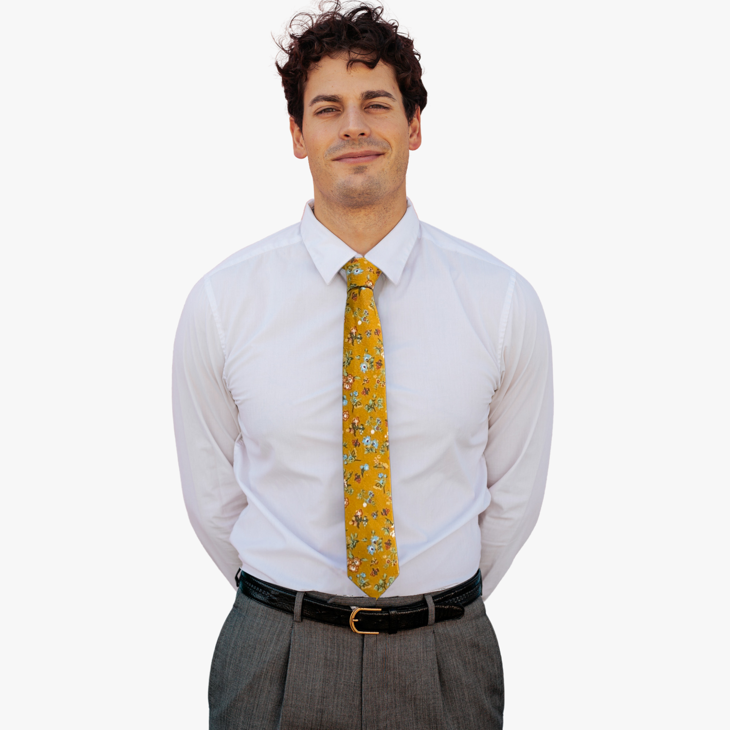 A man wearing a floral tie with mustard yellow fabric, dusty blue flowers, sage green leaves, and red and white accents.
