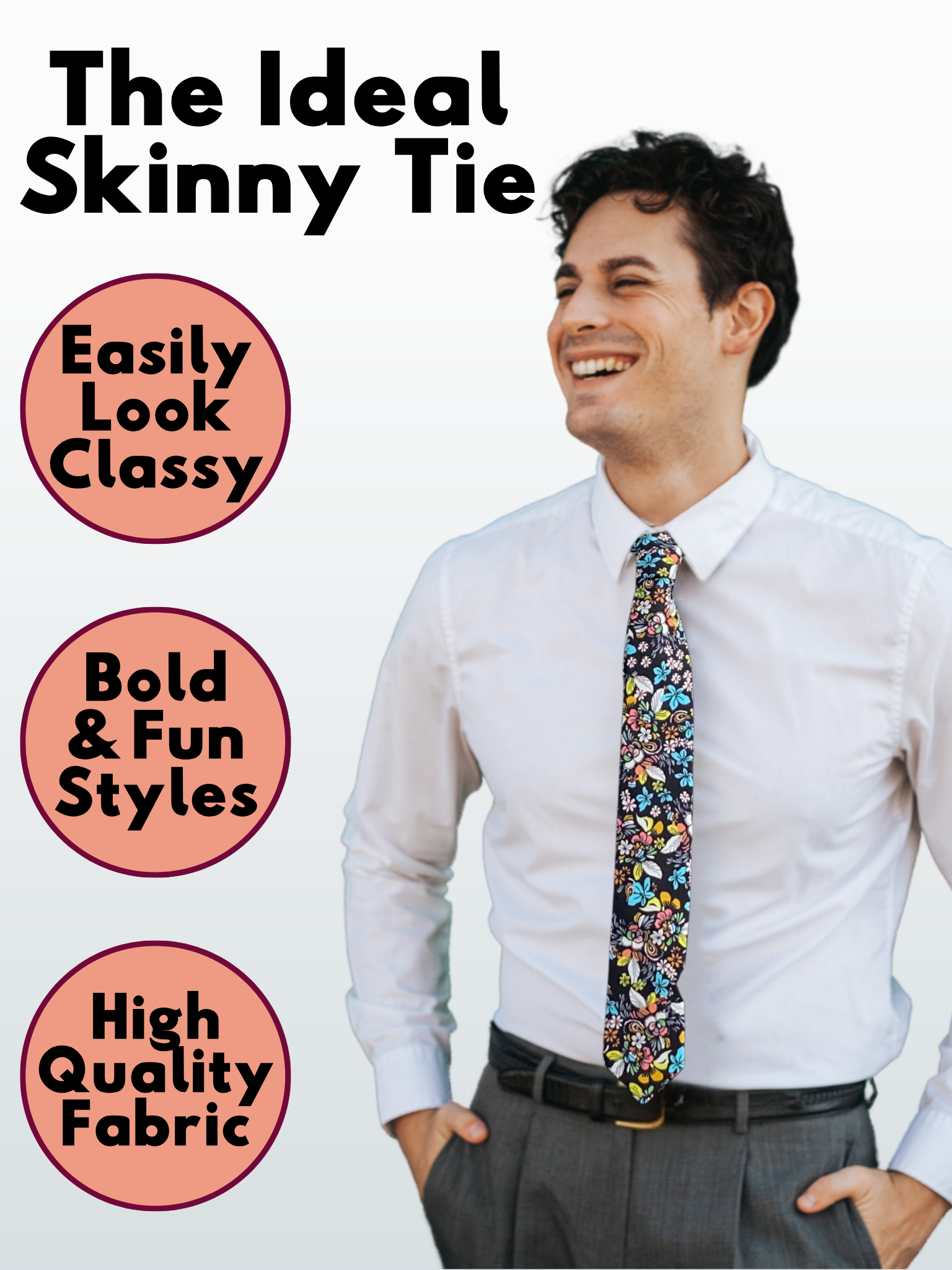 A man in a black, blue, yellow, green, orange, and pink floral modern slim tie that is 2.5 inches wide and made of cotton.