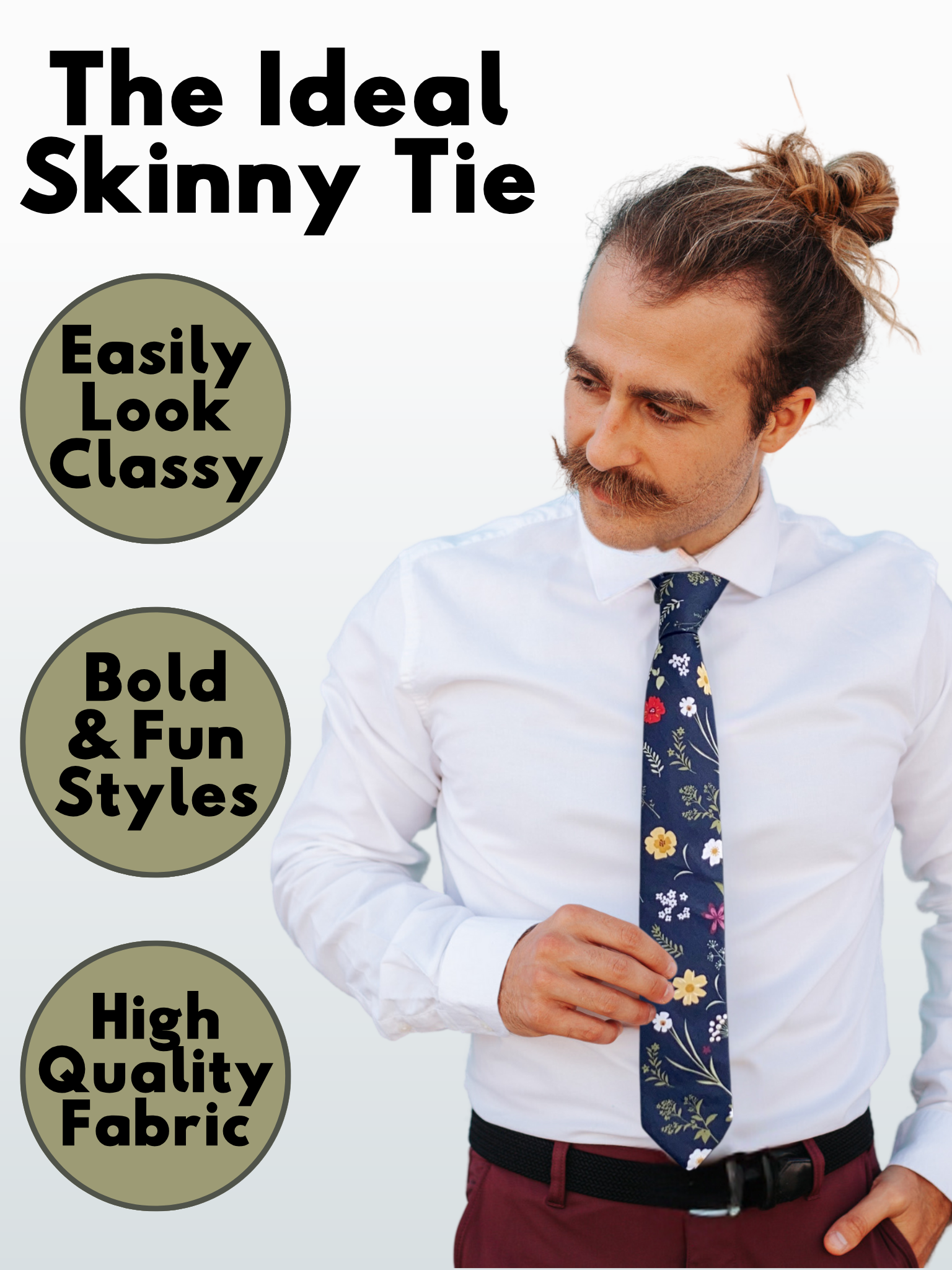 A man in a navy blue, dark green, white, yellow, and red floral modern slim tie that is 2.5 inches wide and made of cotton.