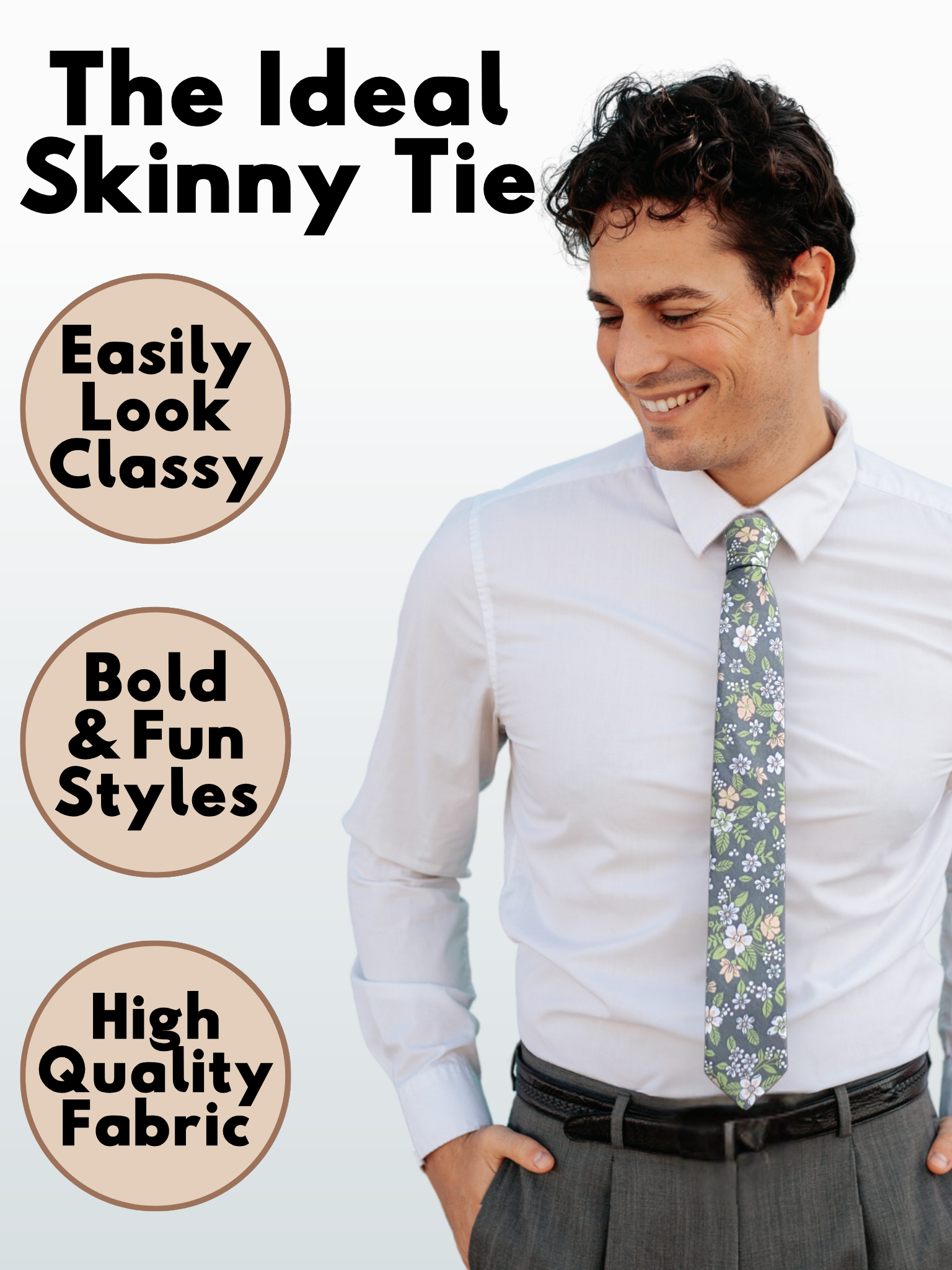 A man in a gray, white, pink petals, and pastel green floral modern slim necktie that is 2.5 inches wide and made of cotton.