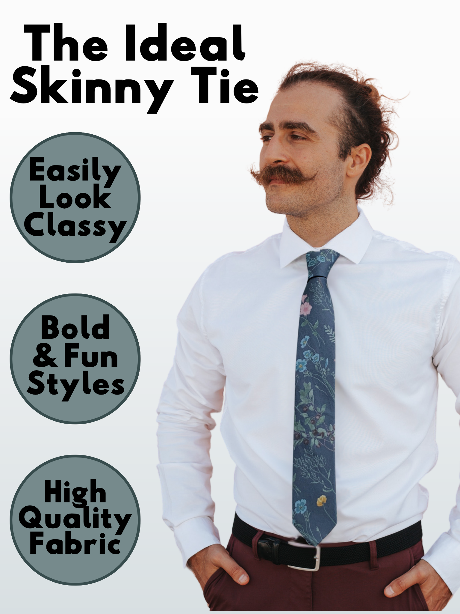 A man in a slate gray, turquoise, teal, pink, and green floral modern slim tie that is 2.5 inches wide and made of cotton.