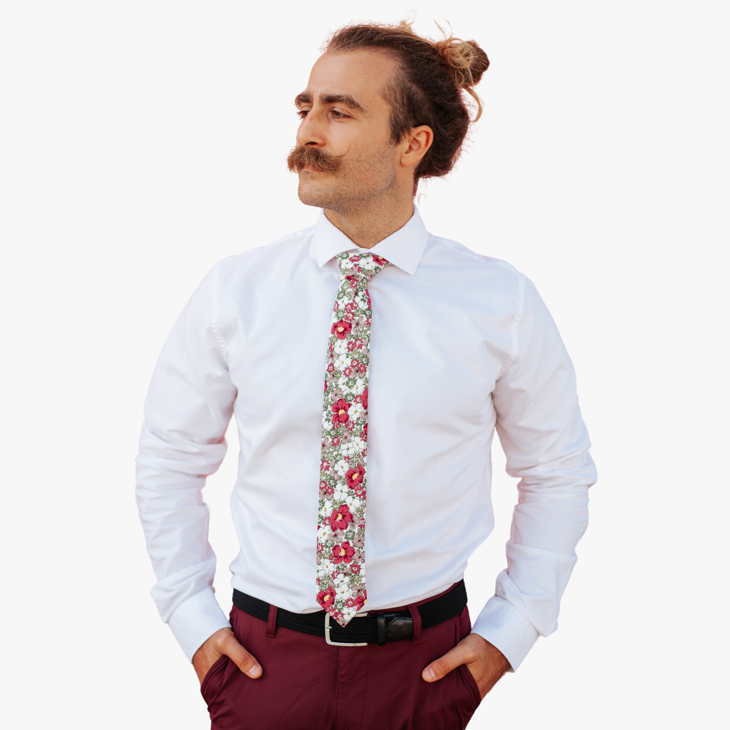 A man in dress clothes wearing a floral tie with purple flowers, lavender or wisteria petals, and olive green blossoms.