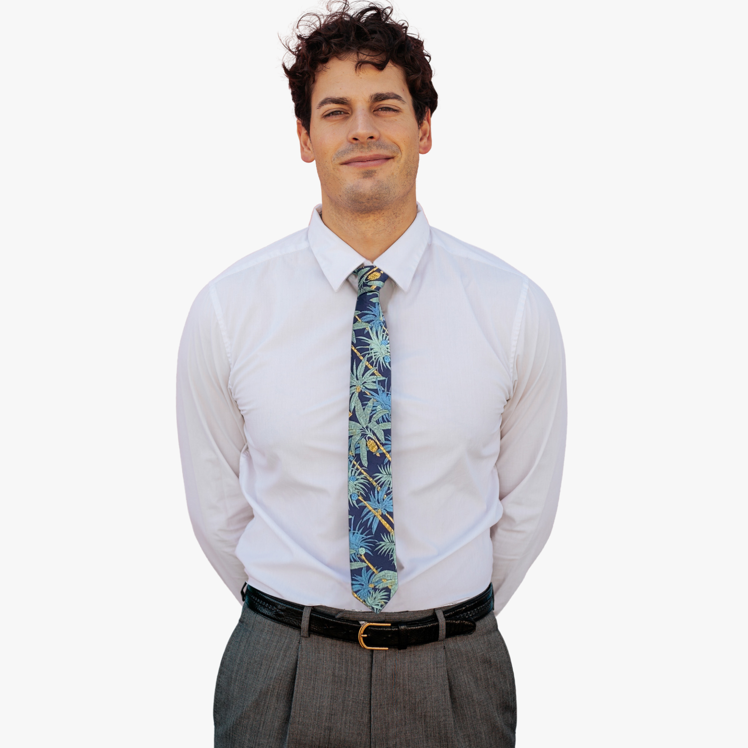 A man wearing a floral tie with navy blue fabric, golden yellow palm trees with light green leaves and dark teal blue palms.