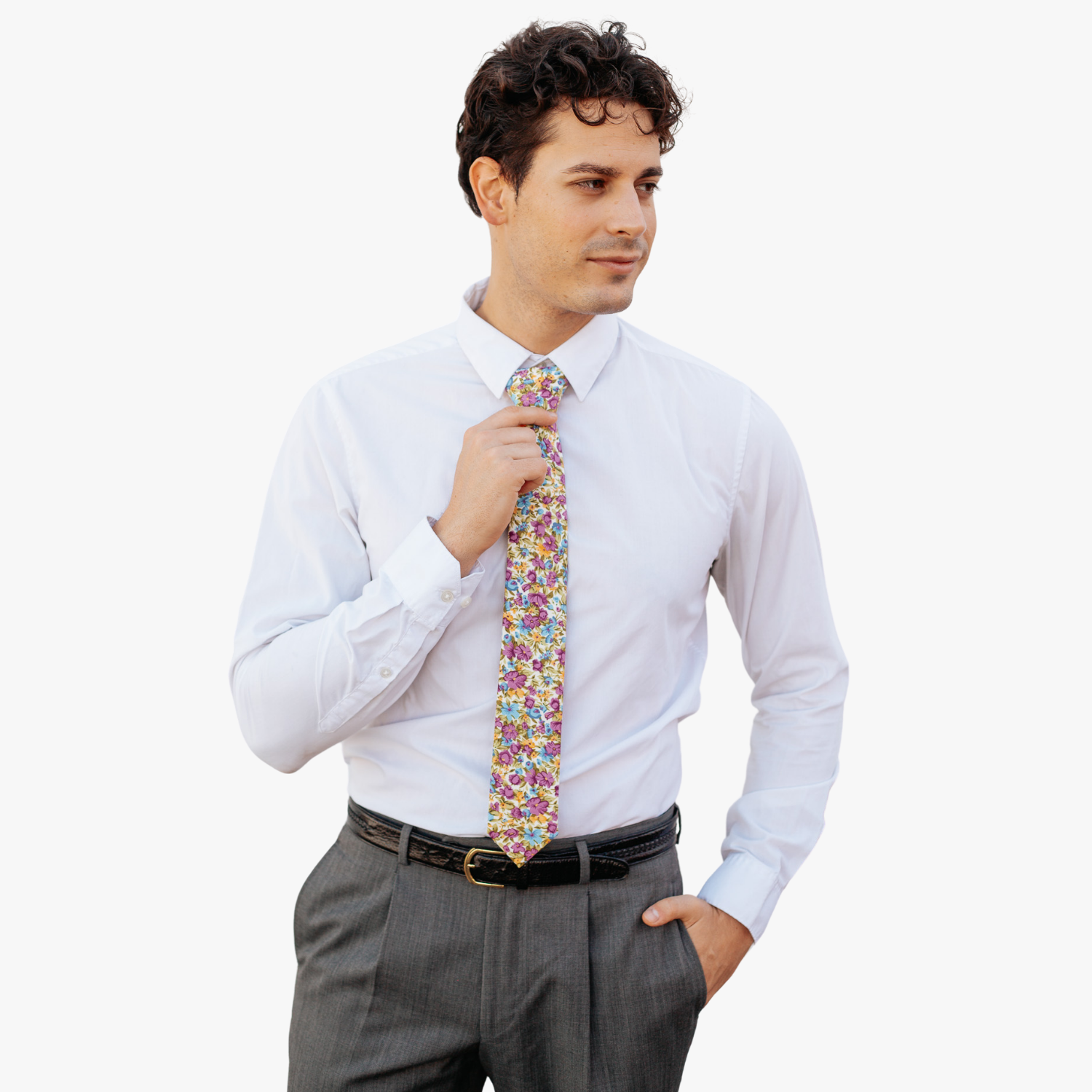 A man in dress clothes wearing a floral tie with  purple flowers, dusty blue petals, yellow spots and pale green leaves.