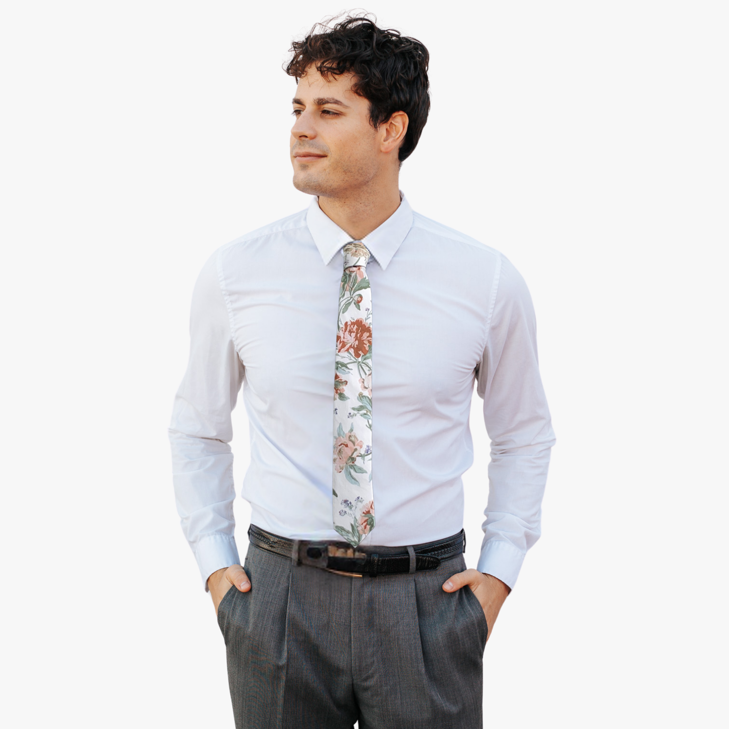 A man wearing a floral tie with offwhite fabric, floral designs of dusty pink flowers, sage green leaves, and purple accents.