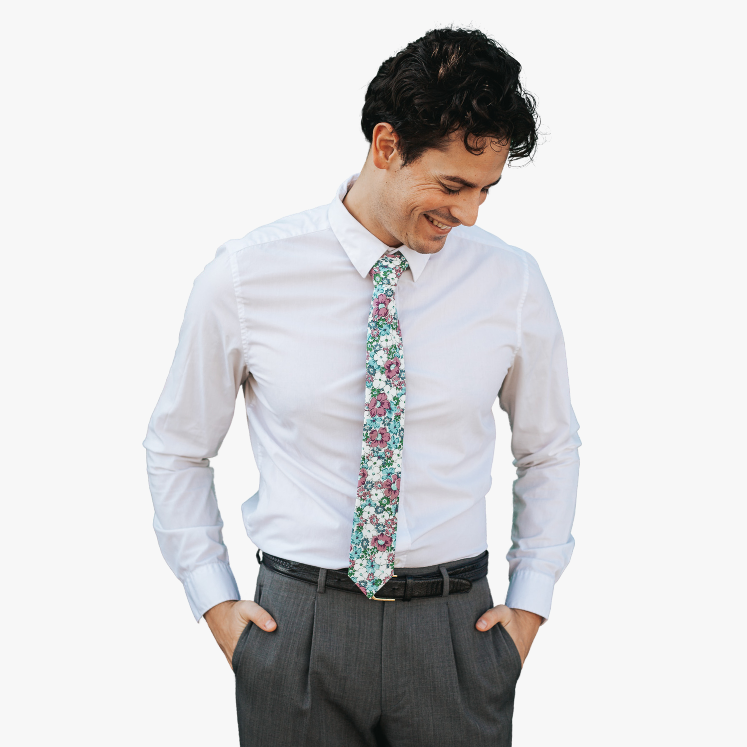 A man in dress clothes wearing a floral tie with blue flowers, lavender purple petals, and green blossoms.
