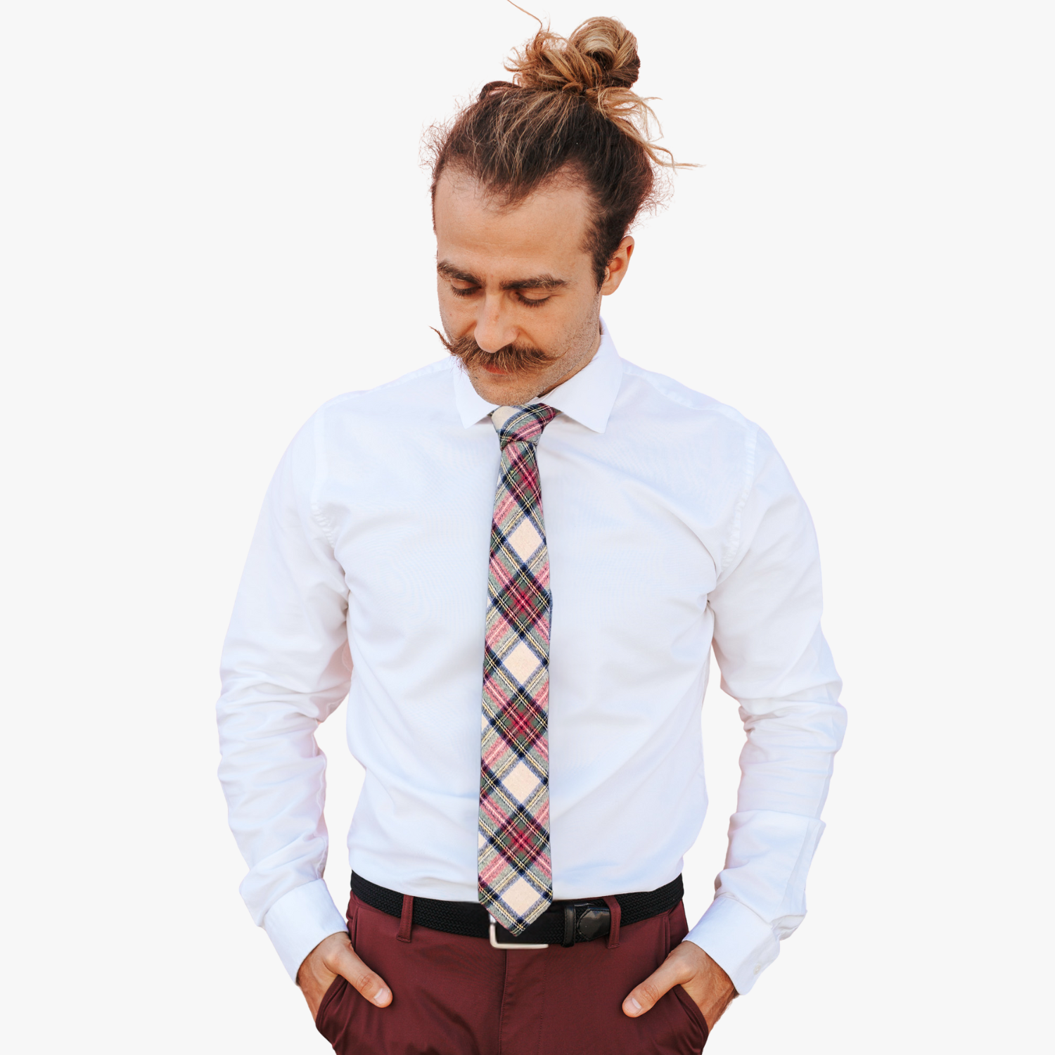 A man wearing a plaid tie with tartan designs of red, green, and blue on white fabric.