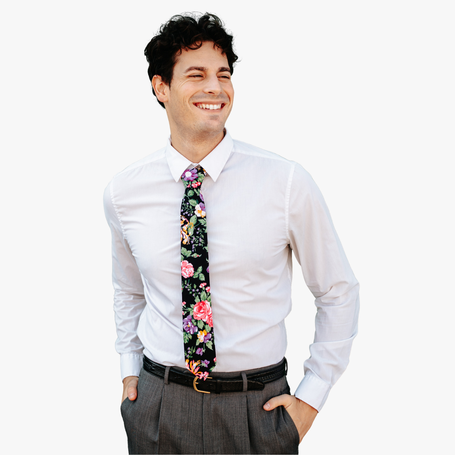 A man in dress clothes wearing a floral tie with pink flowers, orange petals, blue blossoms, and pale green leaves.