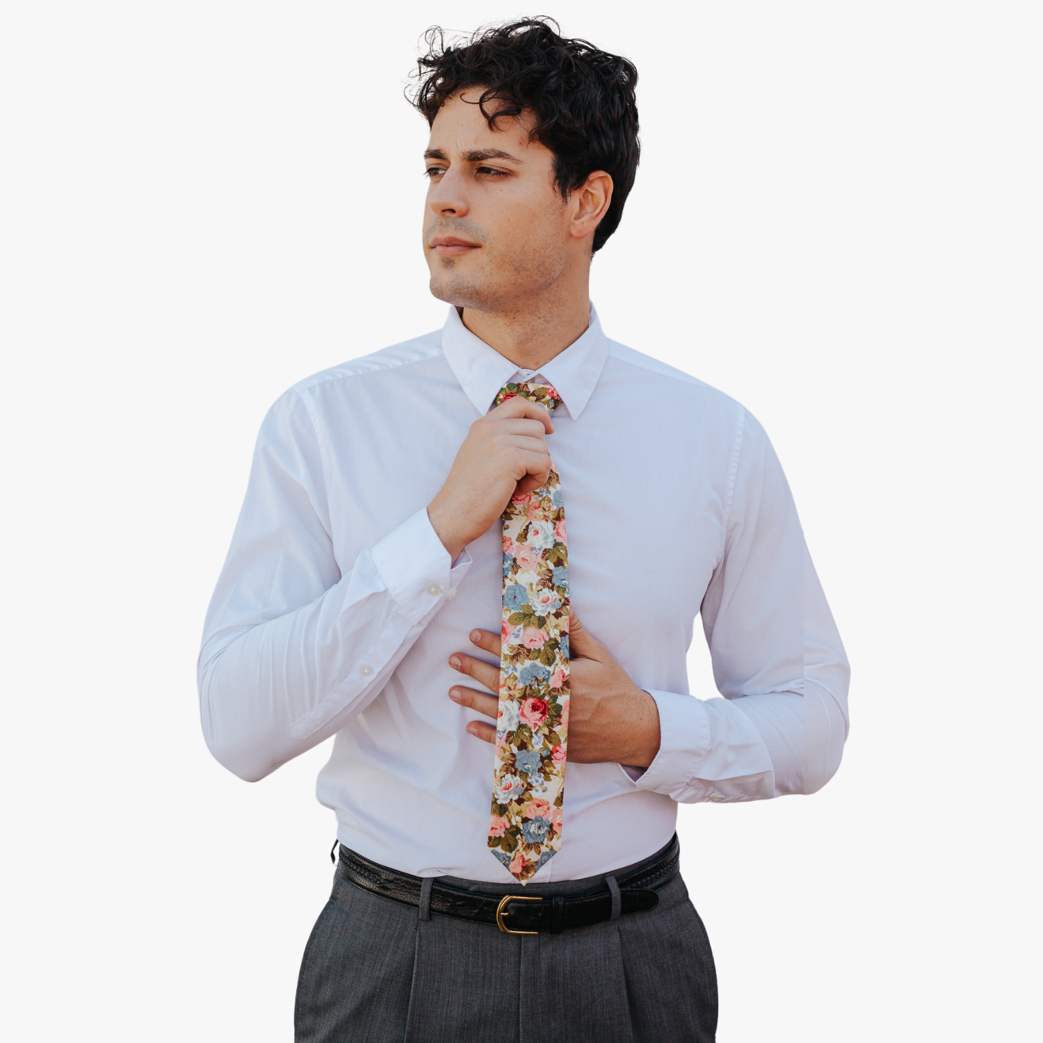 A man in dress clothes wearing a floral tie with Pastel  light pink flowers, dusty blue petals, blossoms and green leaves.