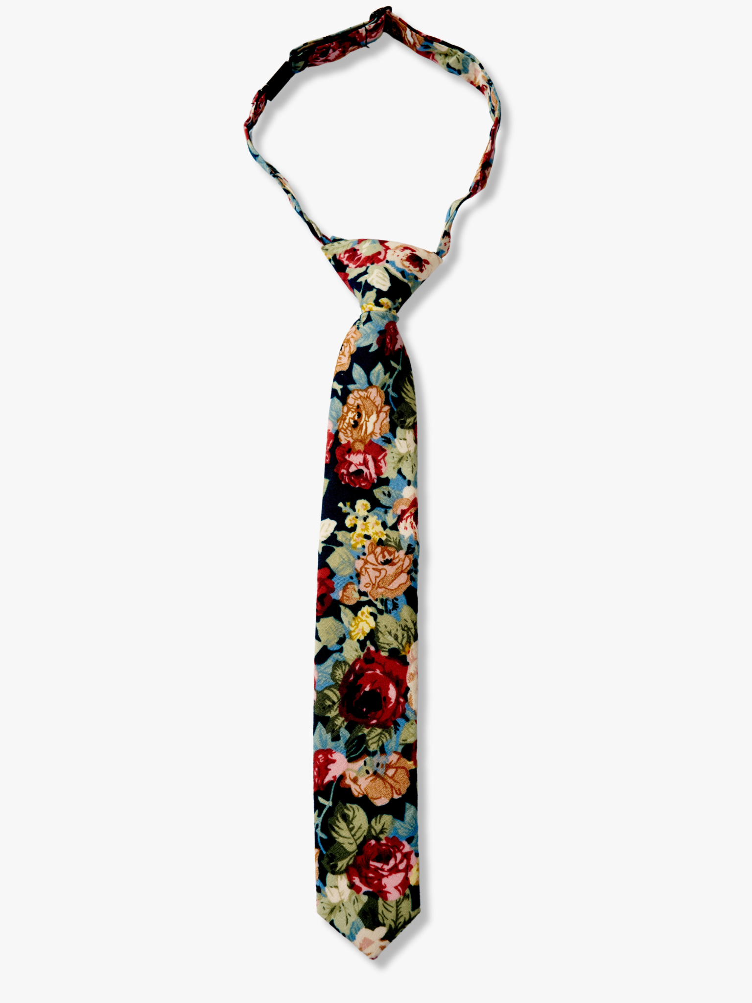 Kids floral pretied tie with dark red flowers, burnt orange petals, rose blossoms and light green leaves on navy blue fabric.