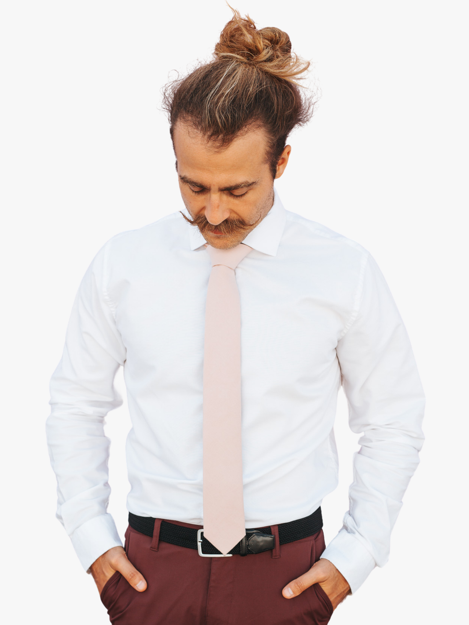 A man with a solid tie with a plain neutral pink taupe color.