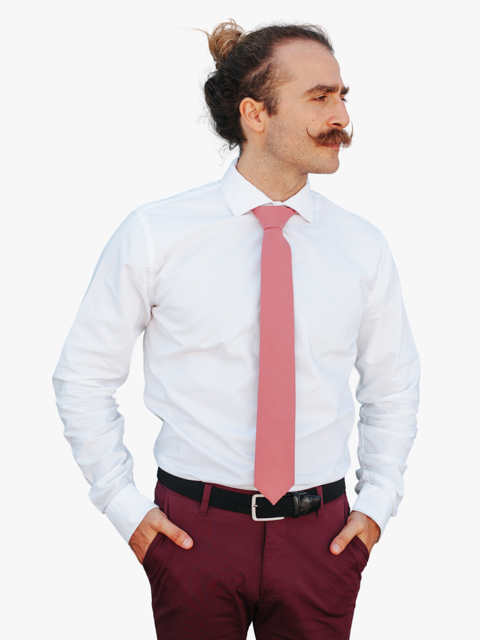 A man with a solid tie with a plain darker rose-gold dusty pink color.