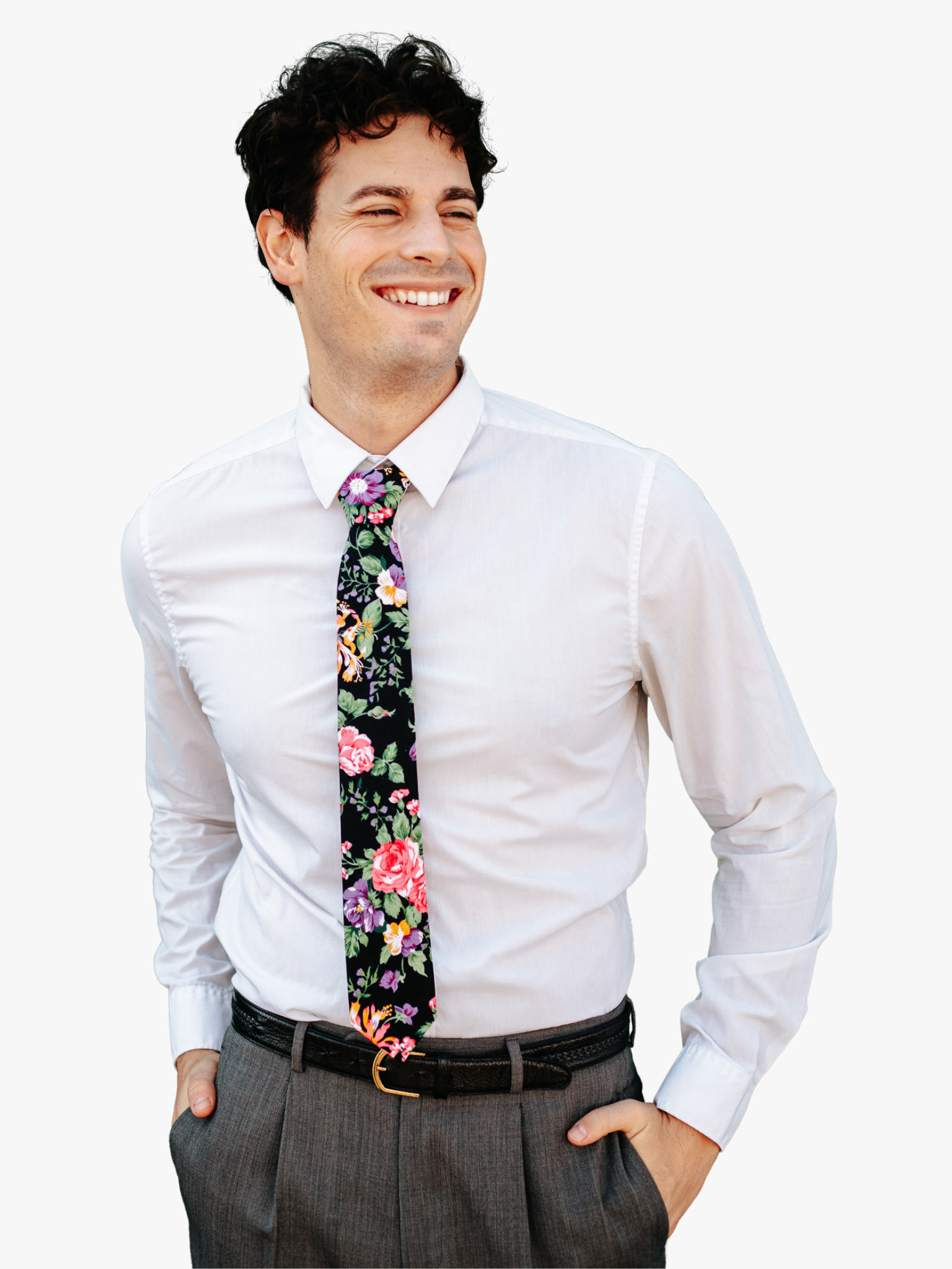 A man in dress clothes wearing a floral tie with pink flowers, orange petals, blue blossoms, and pale green leaves.