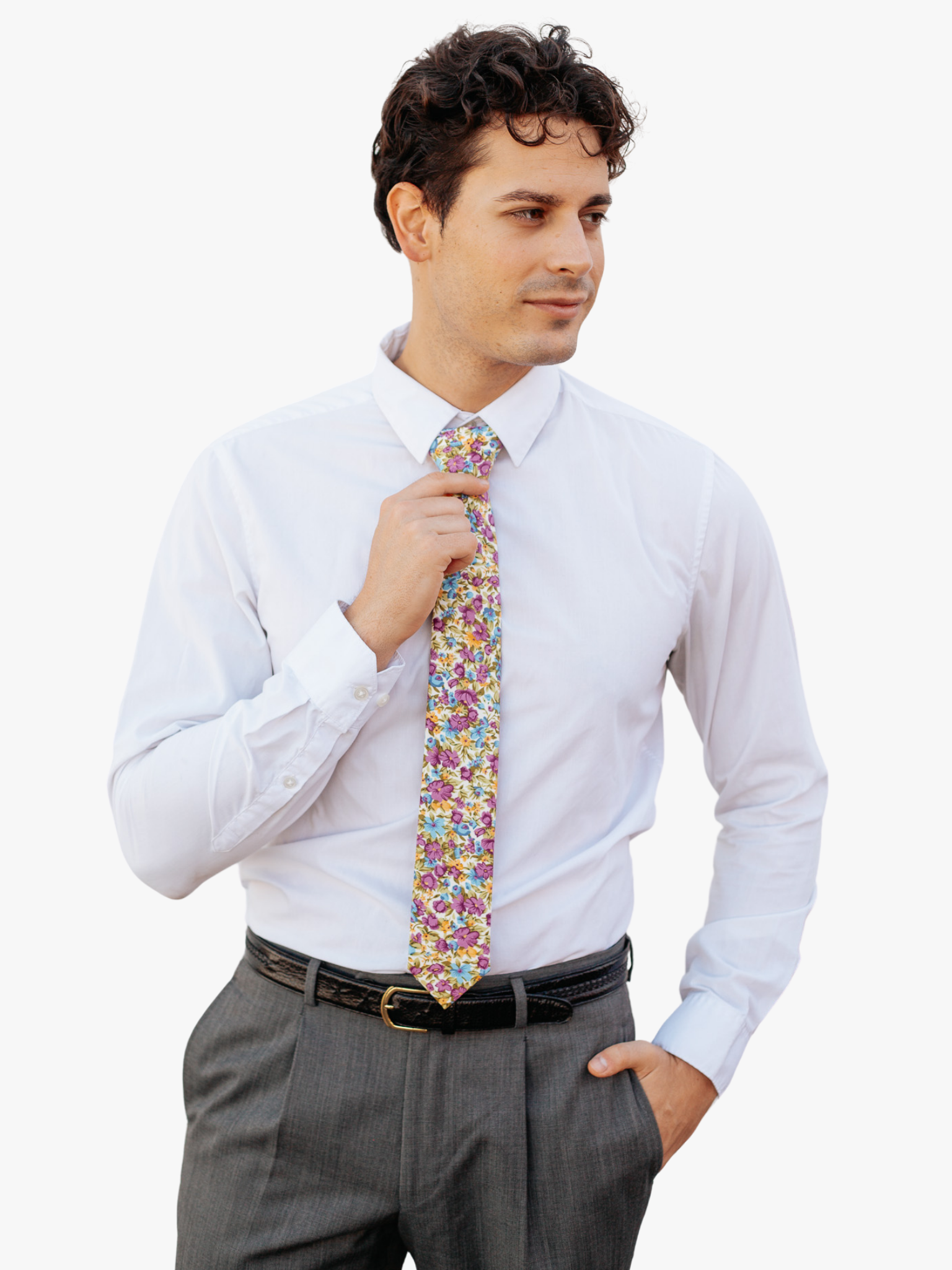 A man in dress clothes wearing a floral tie with  purple flowers, dusty blue petals, yellow spots and pale green leaves.