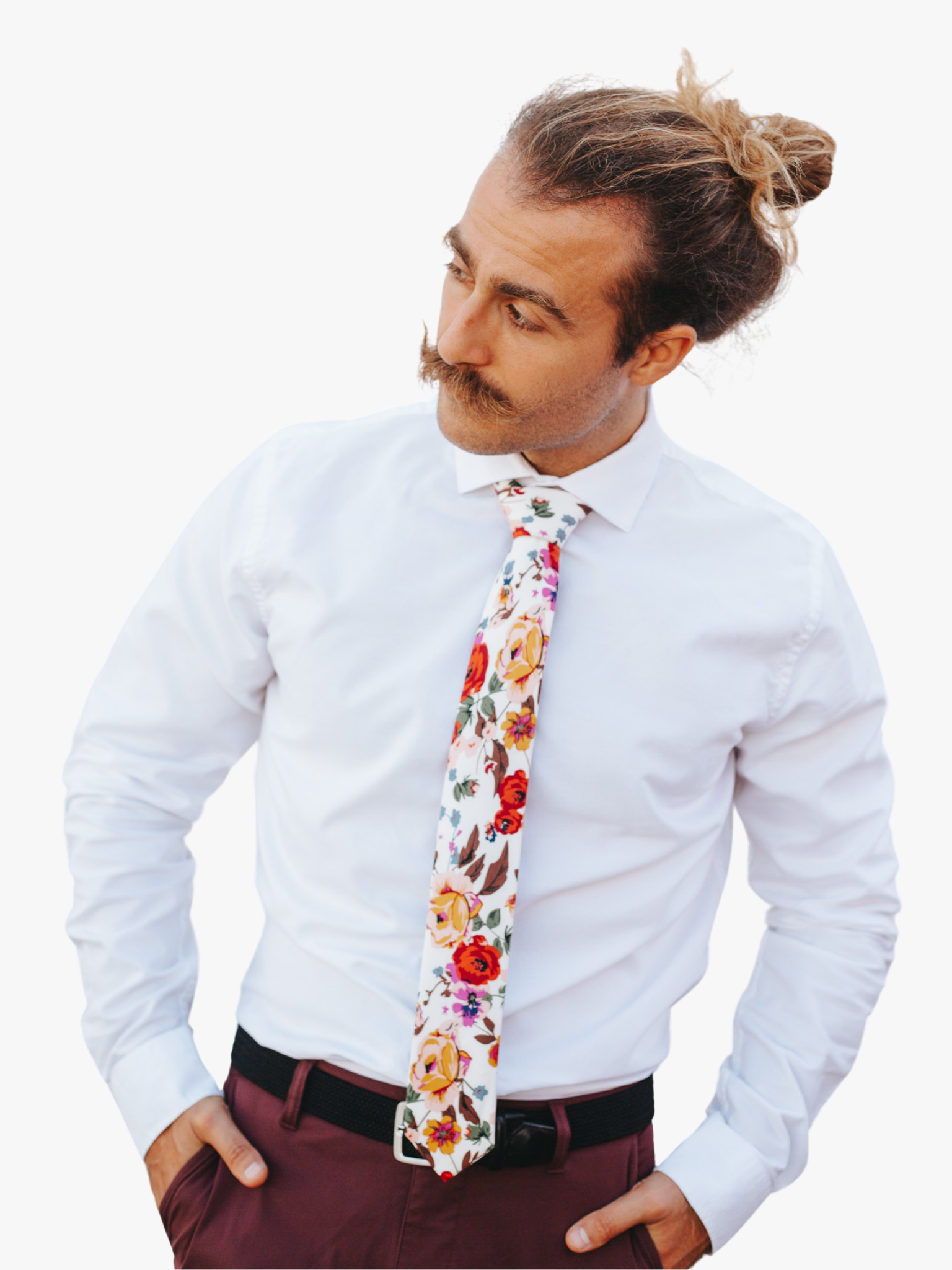 A man wearing a floral tie with  large yellow flowers, orange petals, lavender purple blossoms and green leaves.