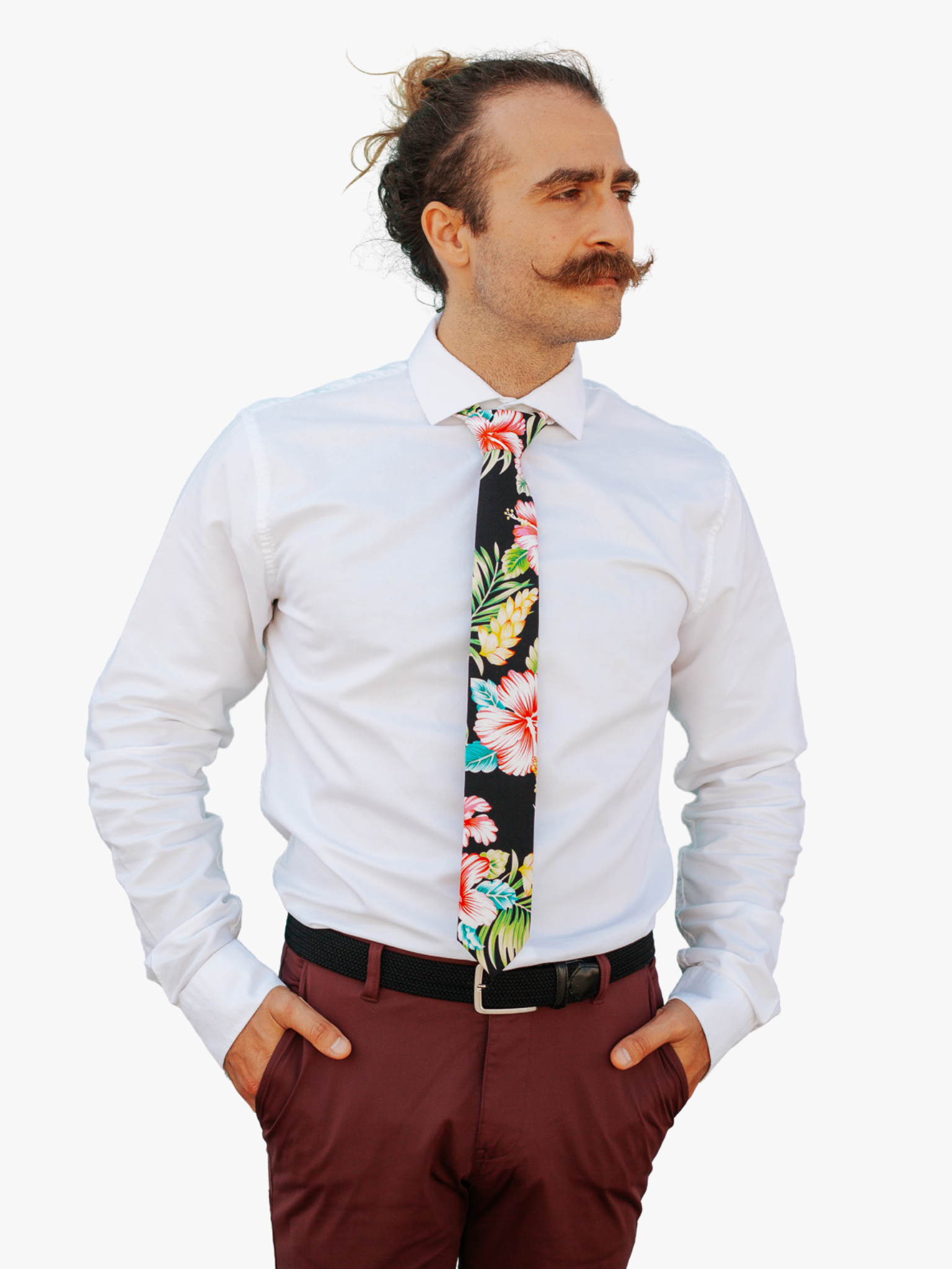 A man in dress clothes wearing a floral tie with Tropical  large pink beach flowers, hibiscus petals, and fern leaves.