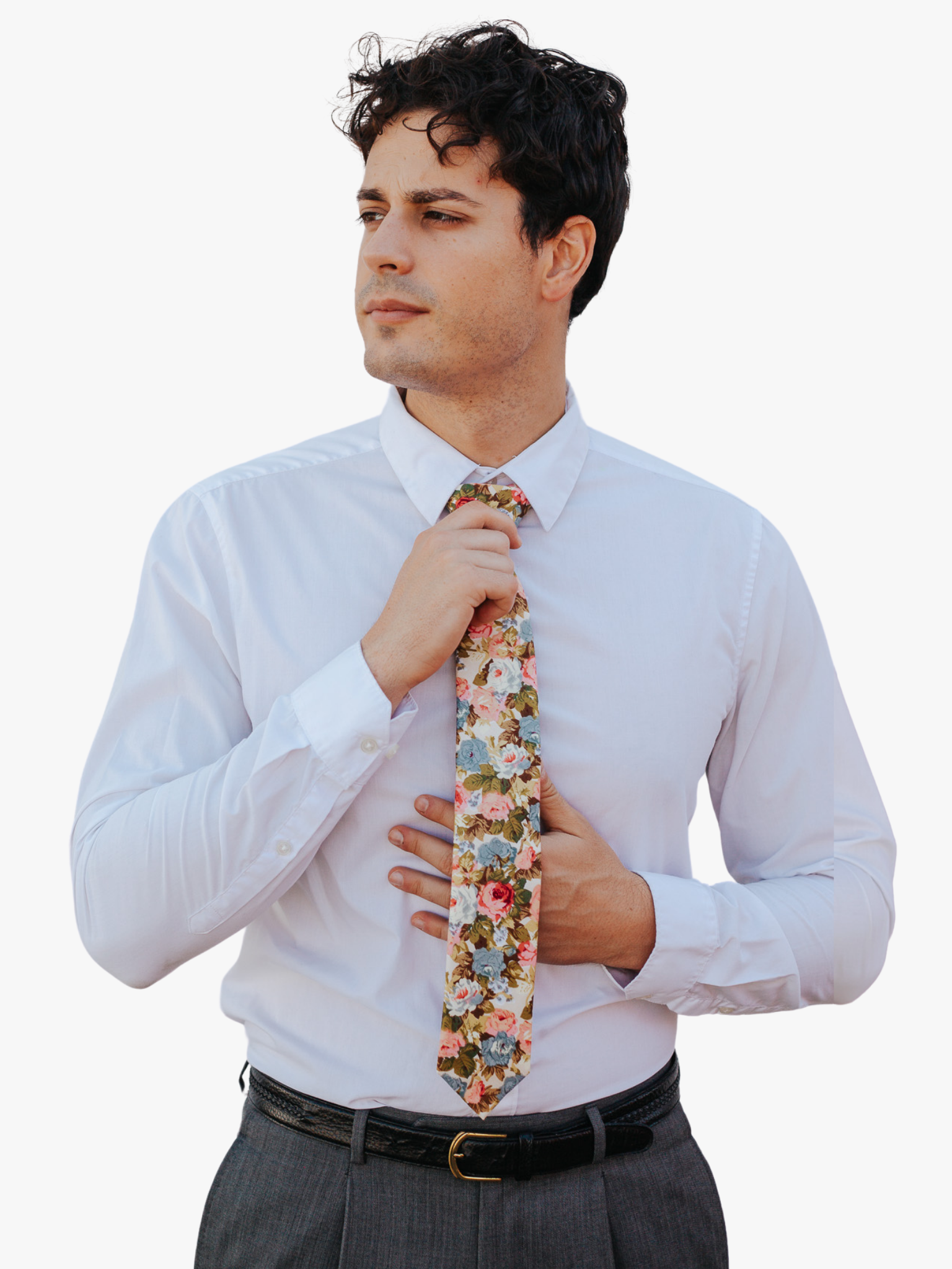 A man in dress clothes wearing a floral tie with Pastel  light pink flowers, dusty blue petals, blossoms and green leaves.