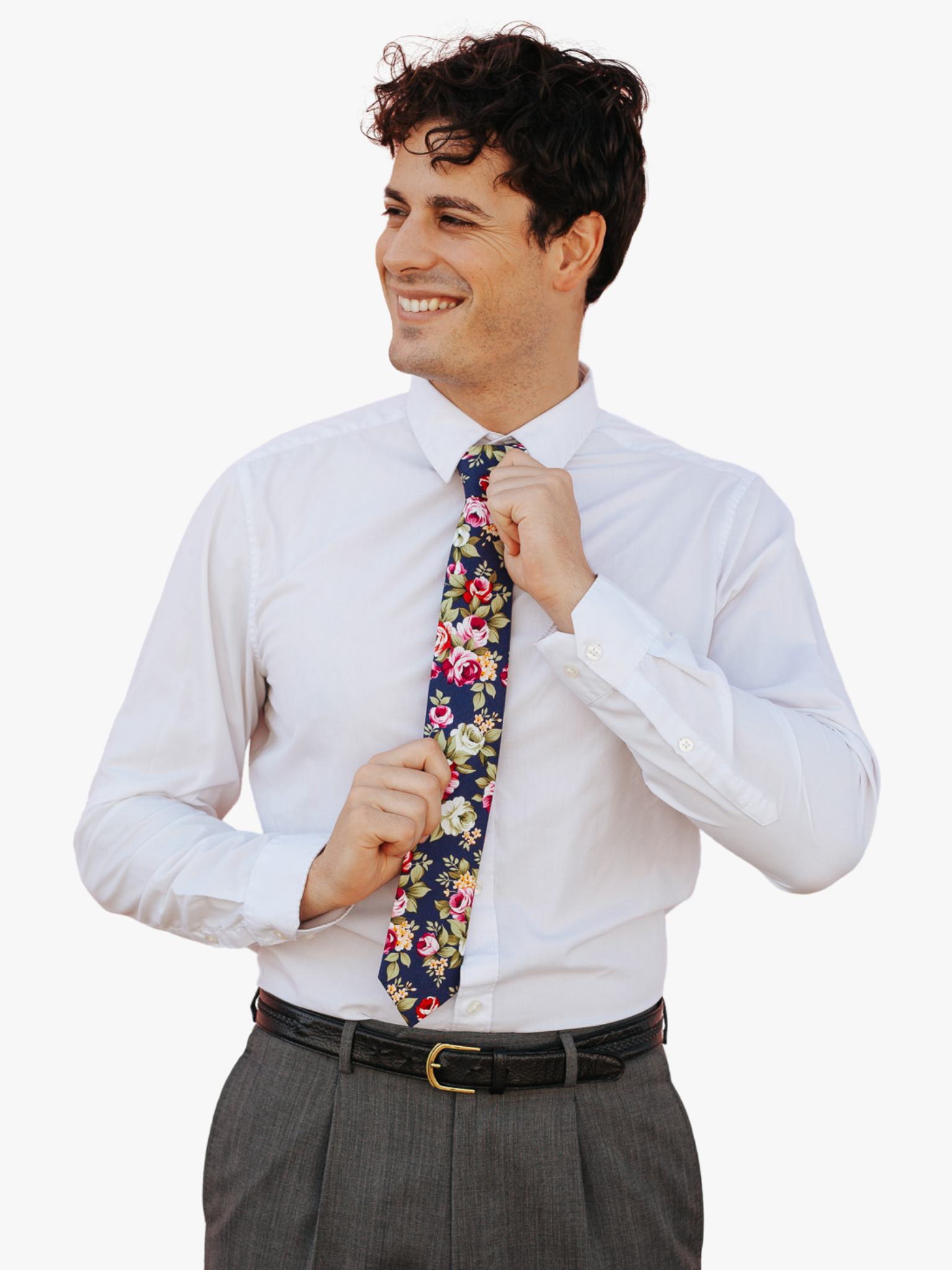 A man in dress clothes wearing a floral tie with pink rose flowers, red petals, yellow blossoms and green leaves.