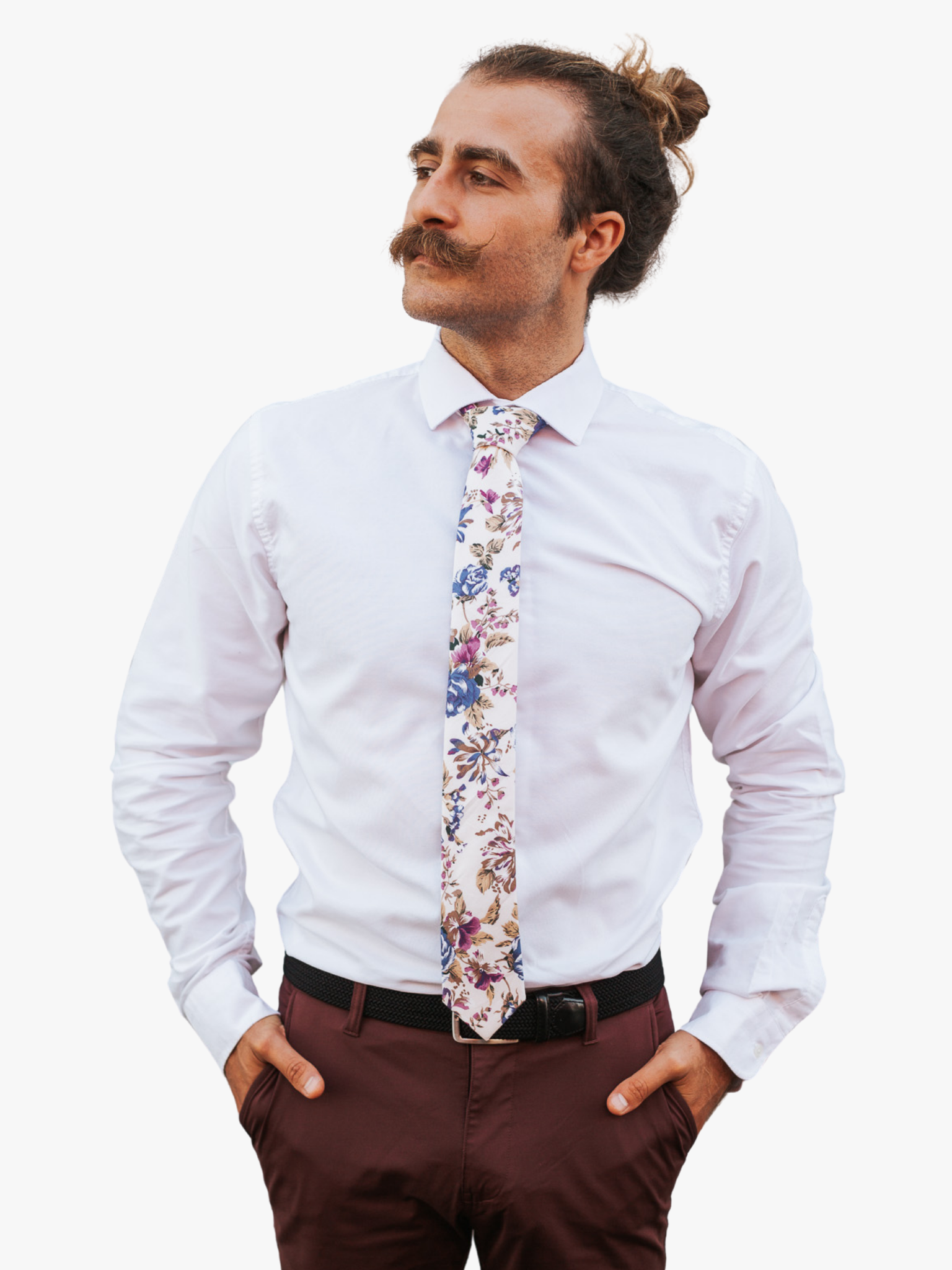 A man in dress clothes wearing a floral tie with purple flowers, blue petals, brown accents and fall leaves.