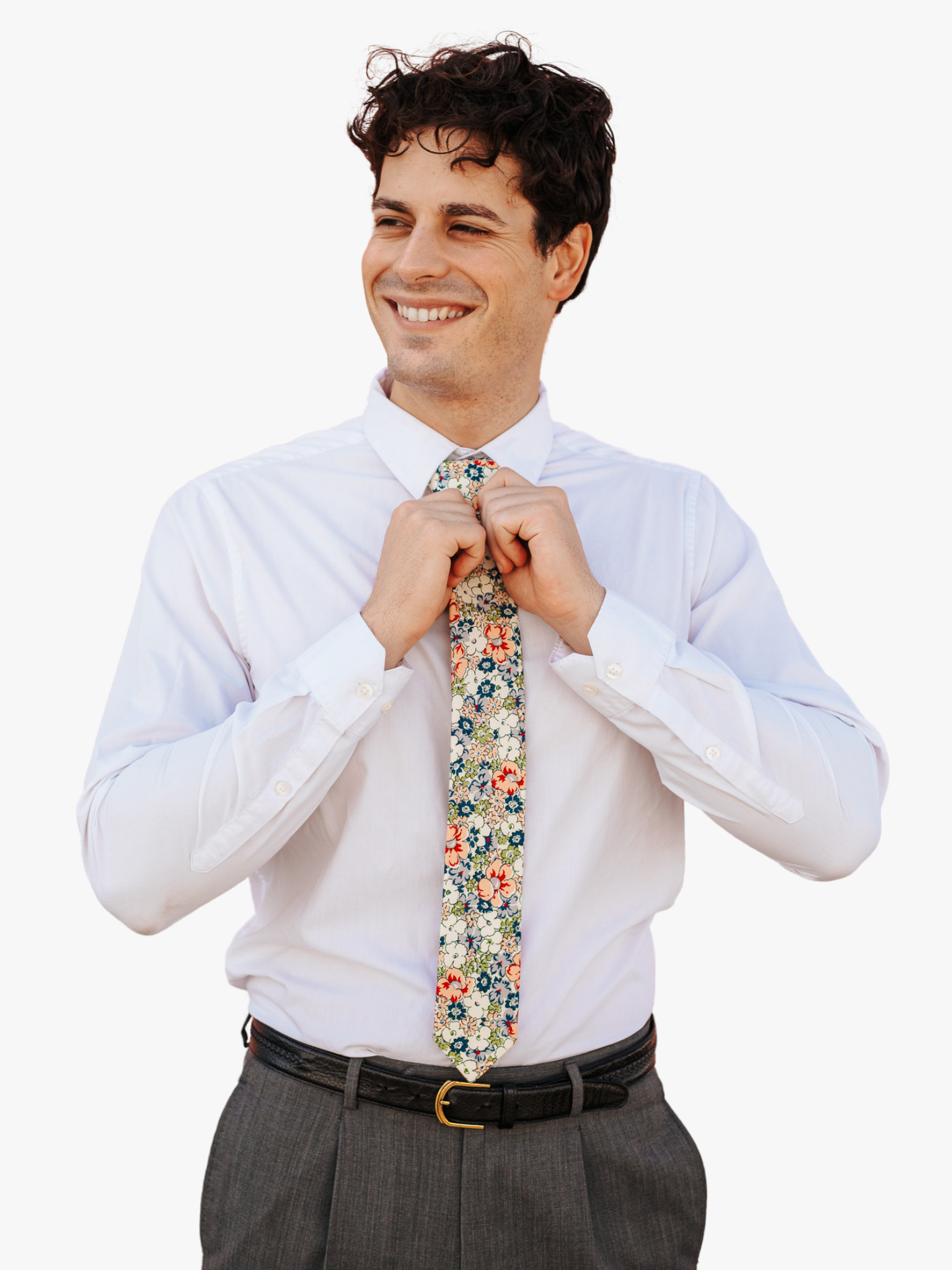 A man in dress clothes wearing a floral tie with blue flowers, white petals, and peach or salmon blossoms and green leaves.