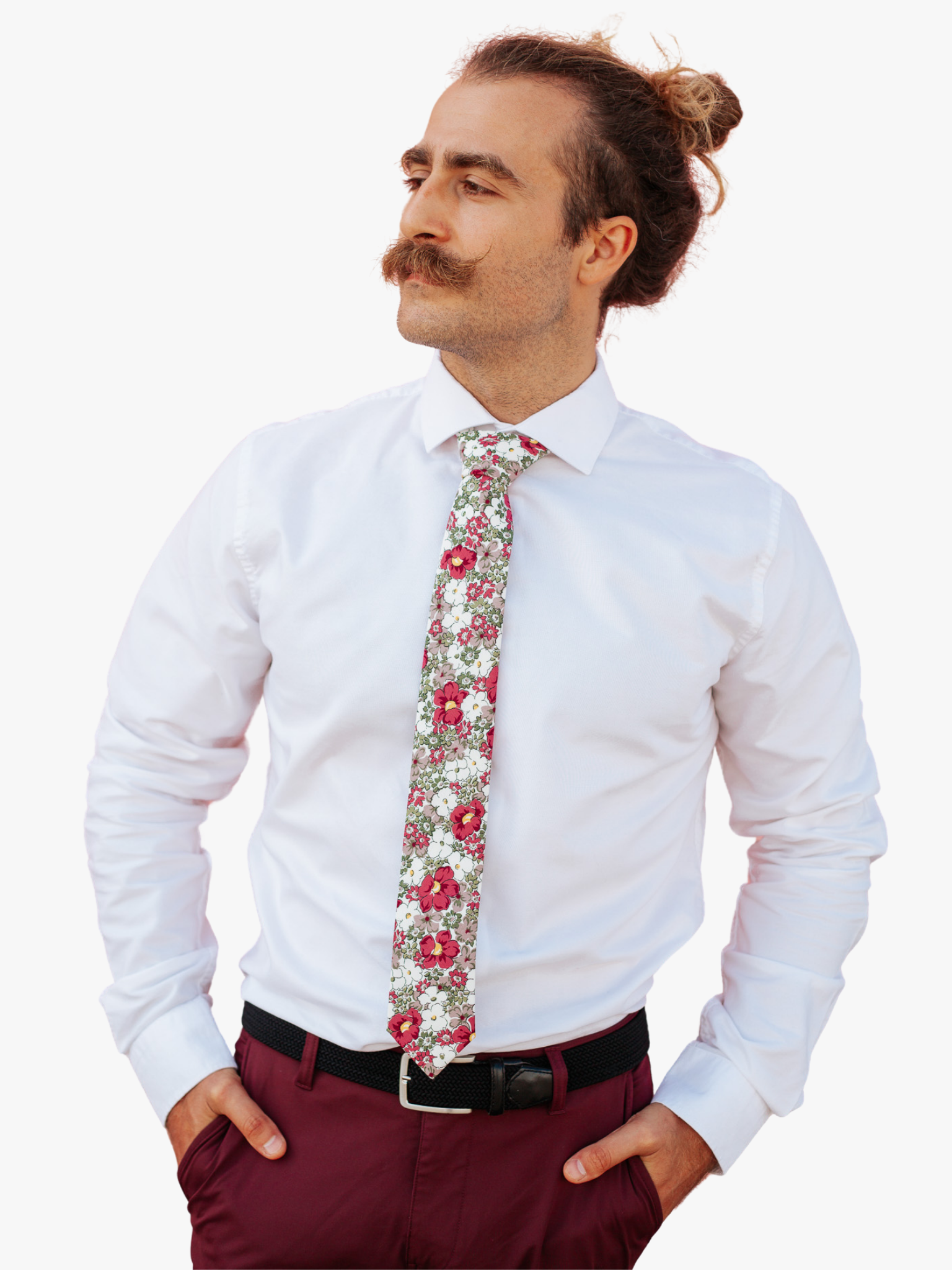 A man in dress clothes wearing a floral tie with purple flowers, lavender or wisteria petals, and olive green blossoms.