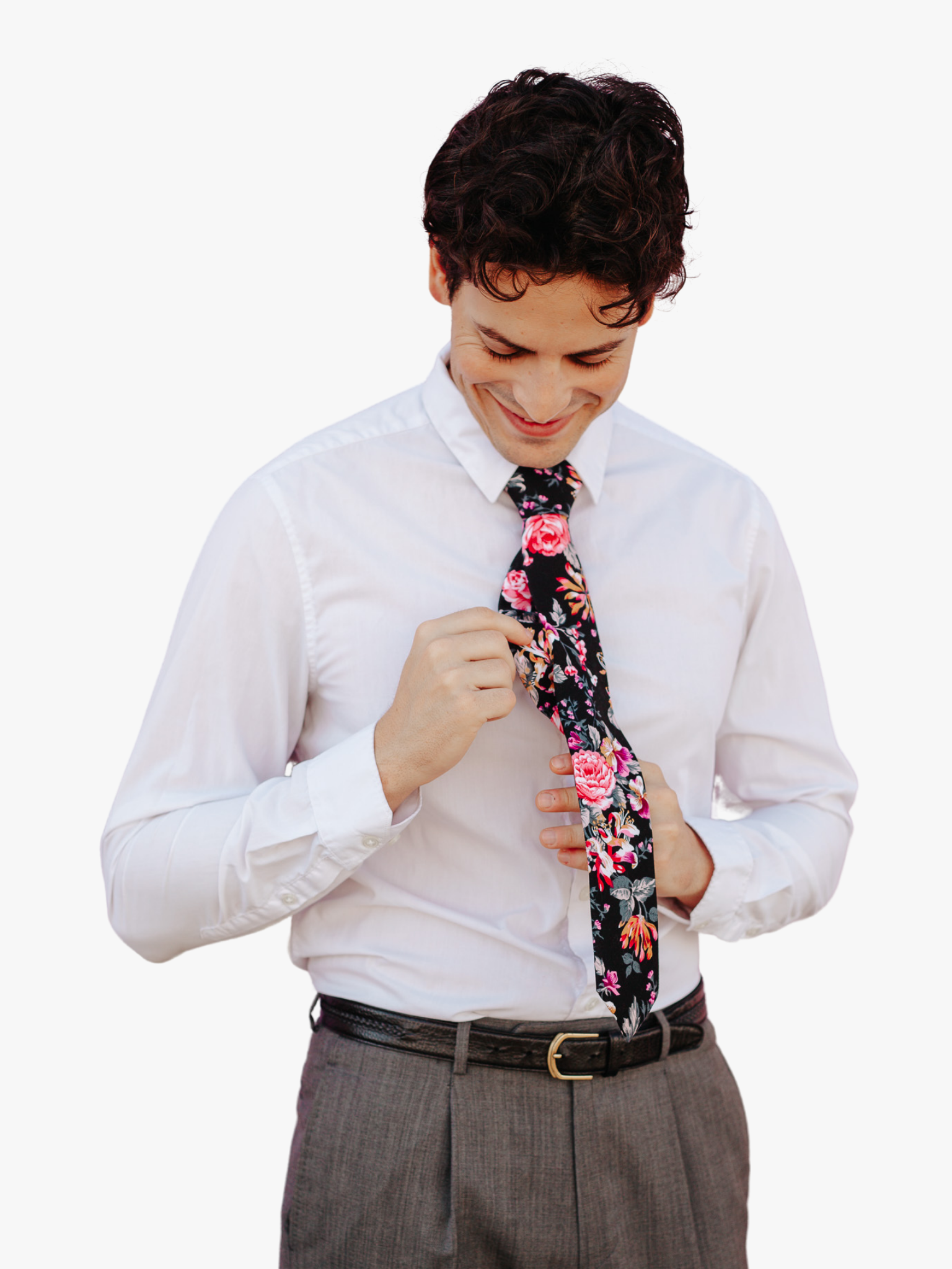 A man wearing a floral tie with burnt orange flowers, pink petals, light purple blossoms, and dark green leaves.