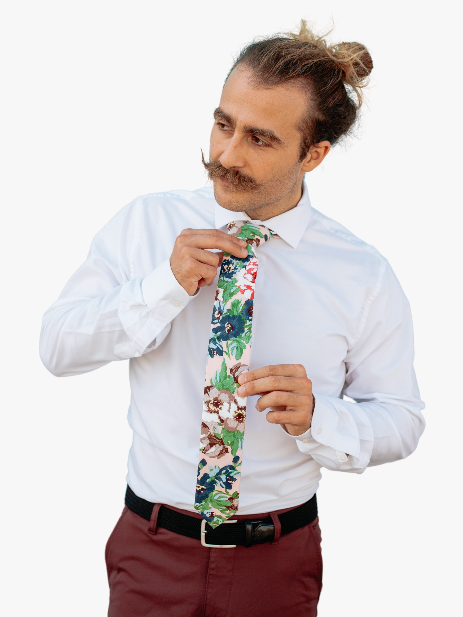 A man in dress clothes wearing a floral tie with dark blue flowers, brown petals, and light green water leaves.