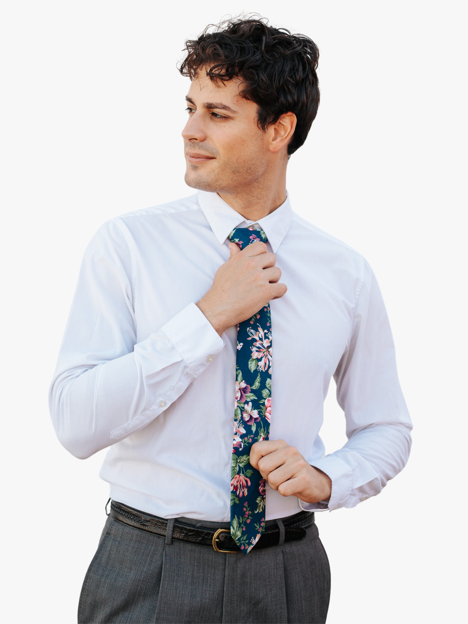 A man in dress clothes wearing a floral tie with pink flowers, Fuchsia petals, light pink blossoms and green leaves.