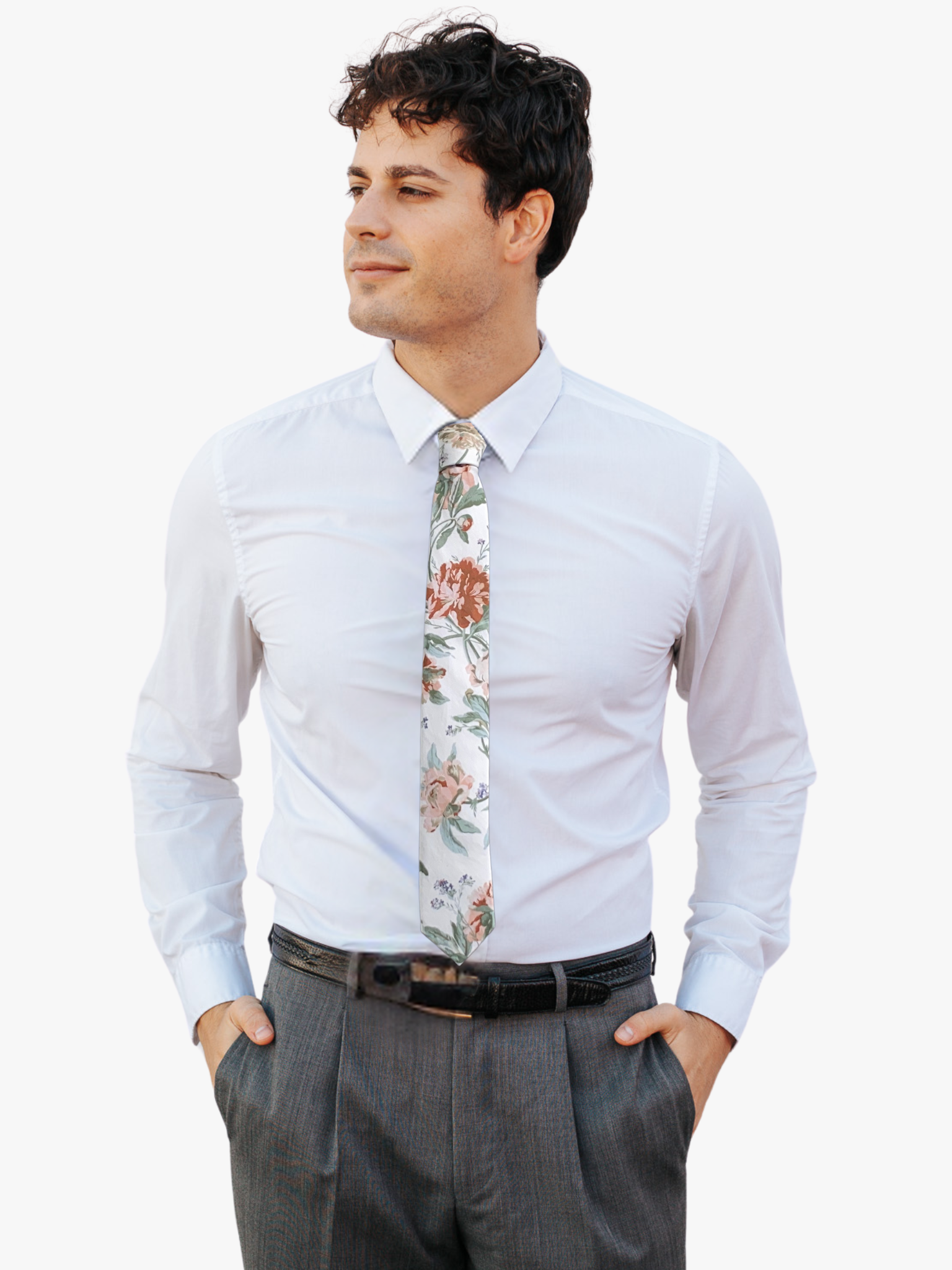 A man wearing a floral tie with offwhite fabric, floral designs of dusty pink flowers, sage green leaves, and purple accents.