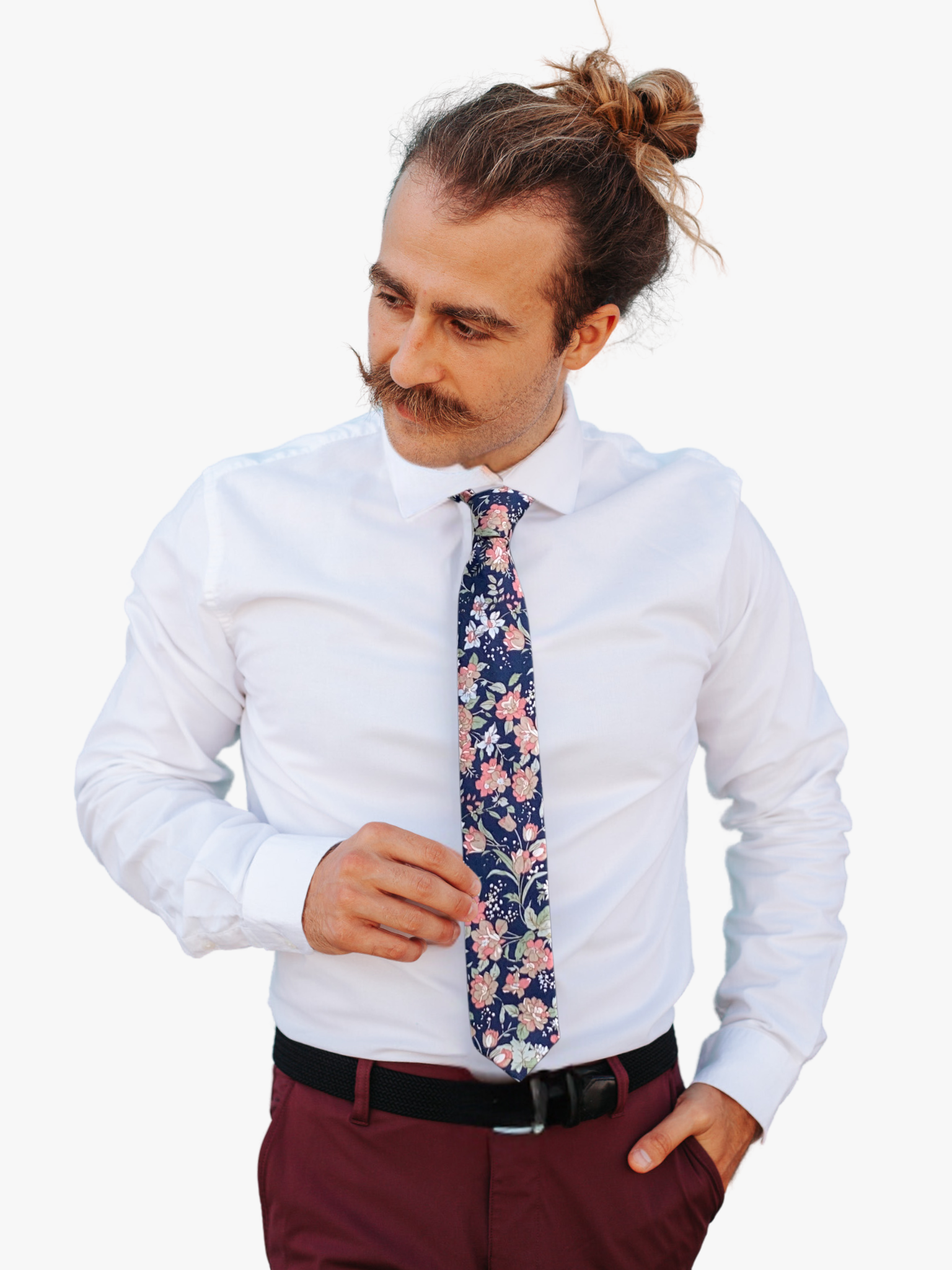 A man wearing a floral tie with deep navy blue fabric, pink and brown flowers, pastel sage green leaves, and white flowers.