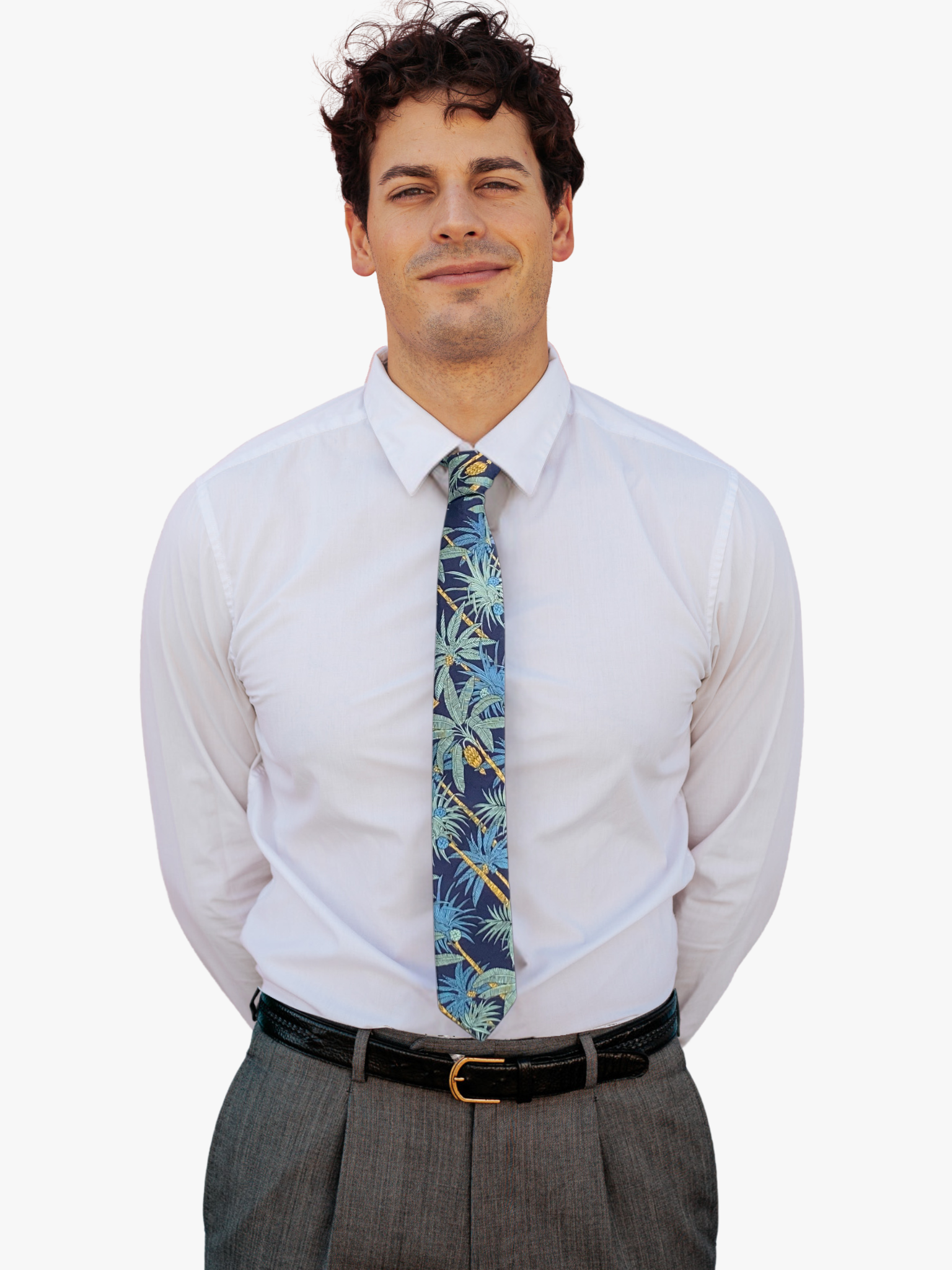 A man wearing a floral tie with navy blue fabric, golden yellow palm trees with light green leaves and dark teal blue palms.